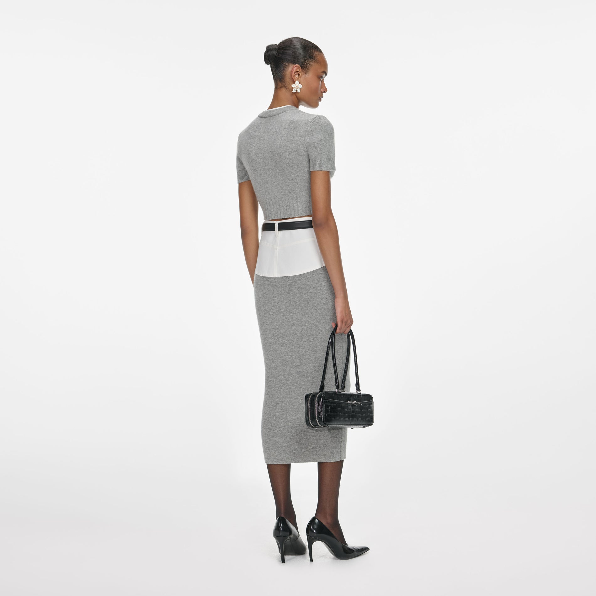 Back view of a woman wearing the Grey Knit Denim Insert Midi Skirt