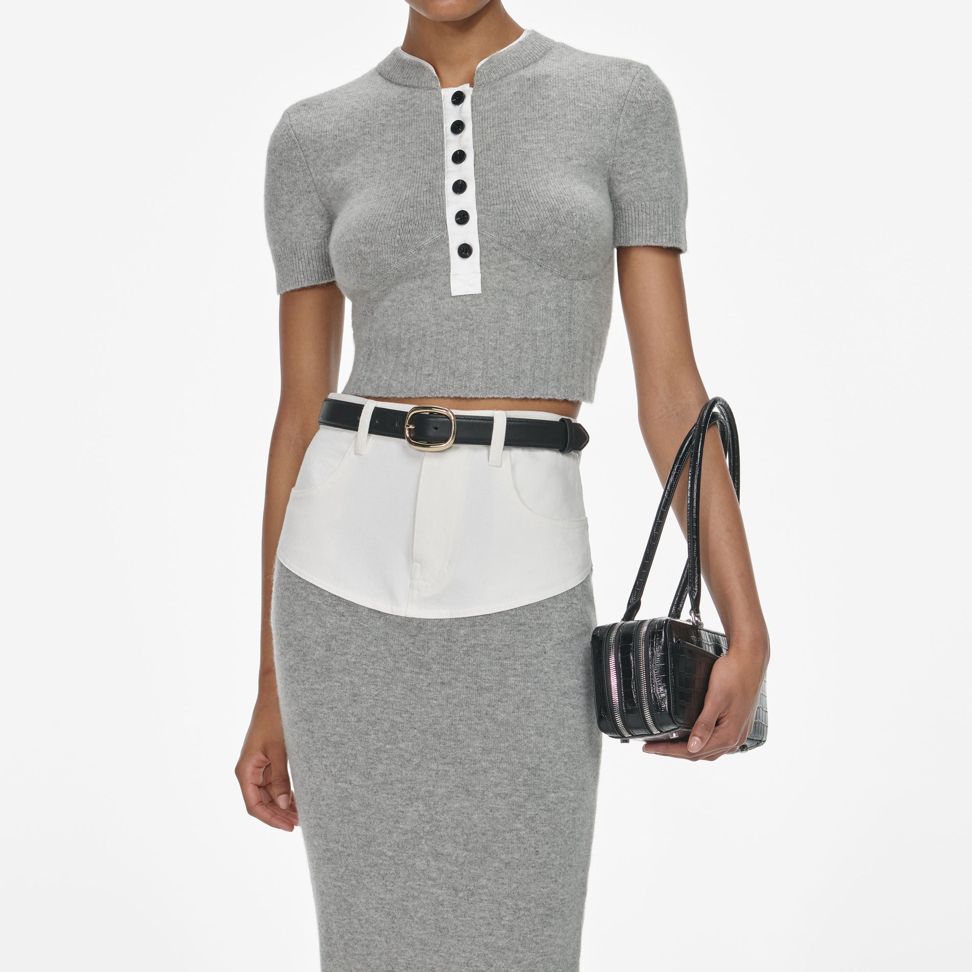 A close up of a woman wearing the Grey Short Sleeve Knit Top