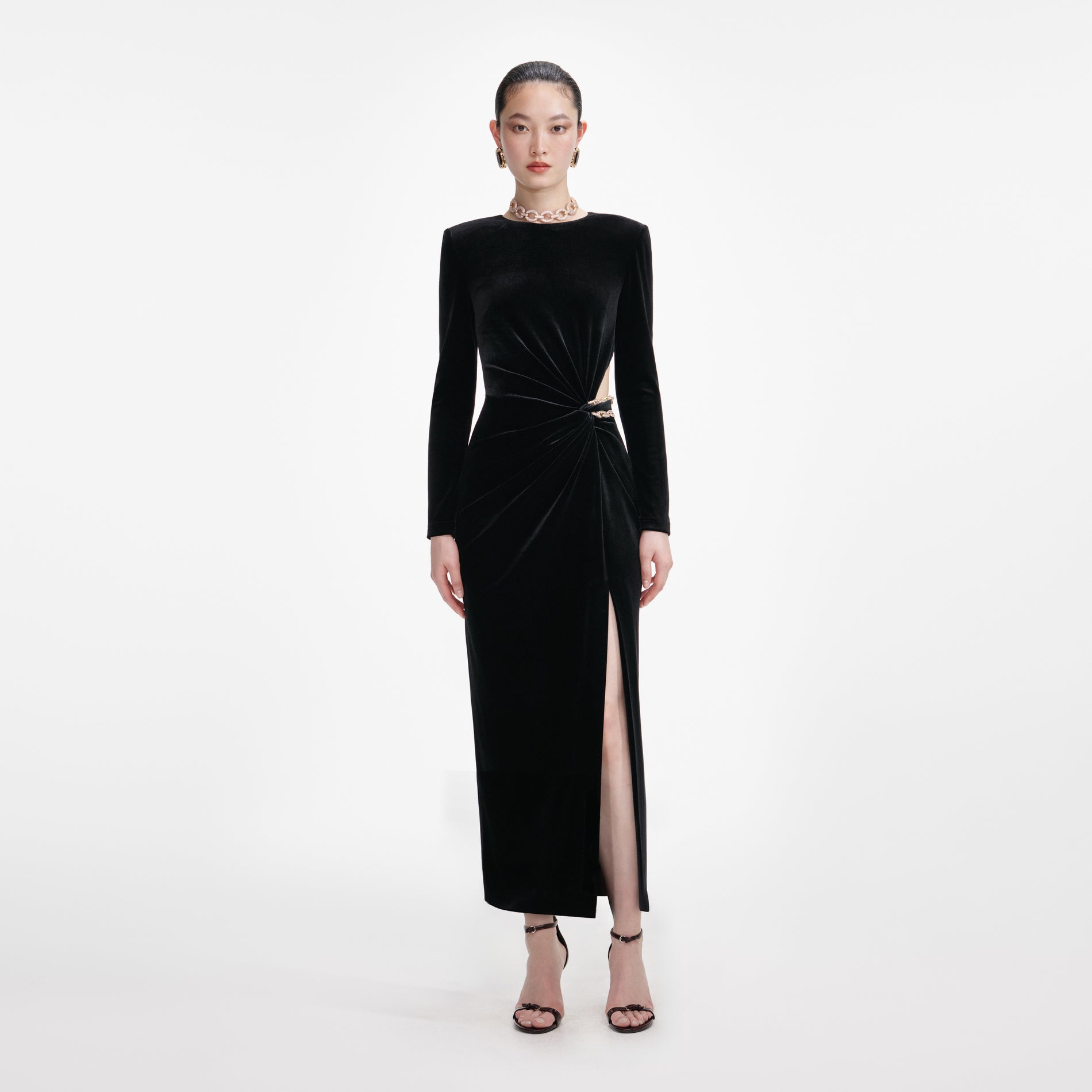 Front view of a woman wearing the Black Velvet Embellished Midi Dress