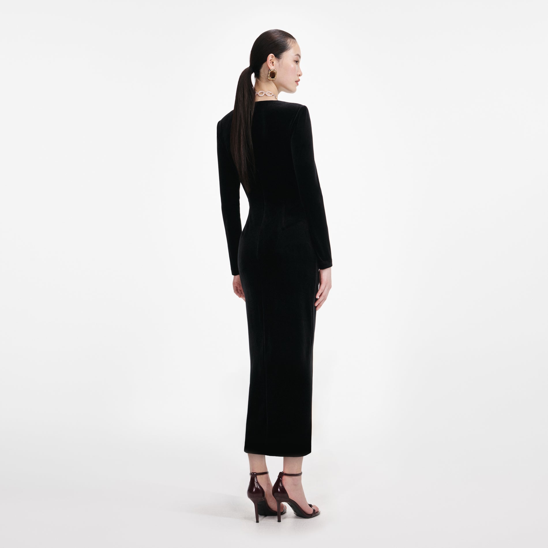 Back view of a woman wearing the Black Velvet Embellished Midi Dress
