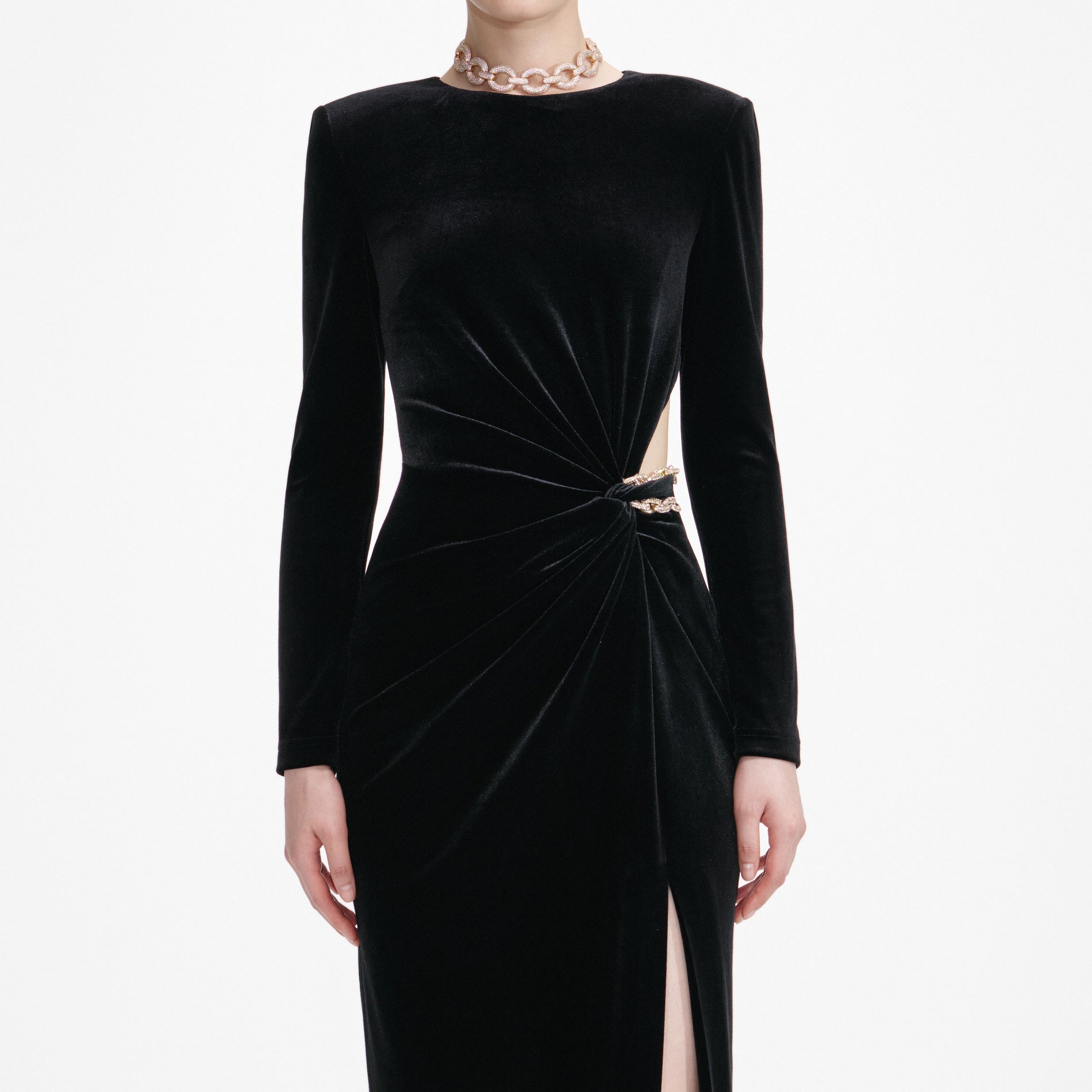 A close up of a woman wearing the Black Velvet Embellished Midi Dress