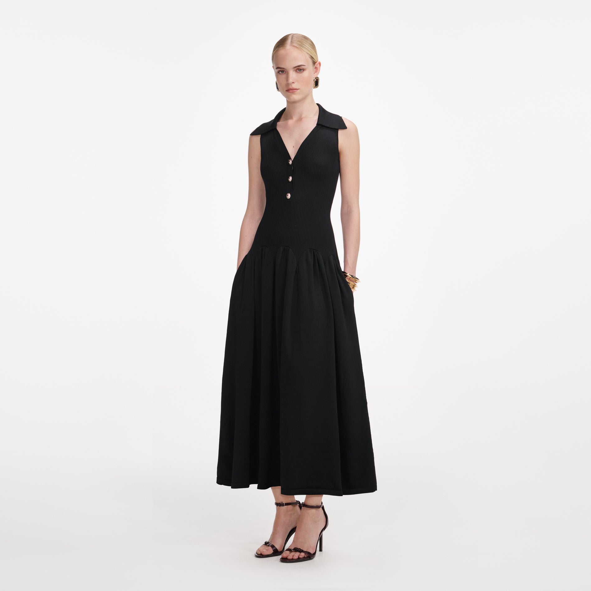 Side view of a woman wearing the Black Ribbed Knit Midi Dress