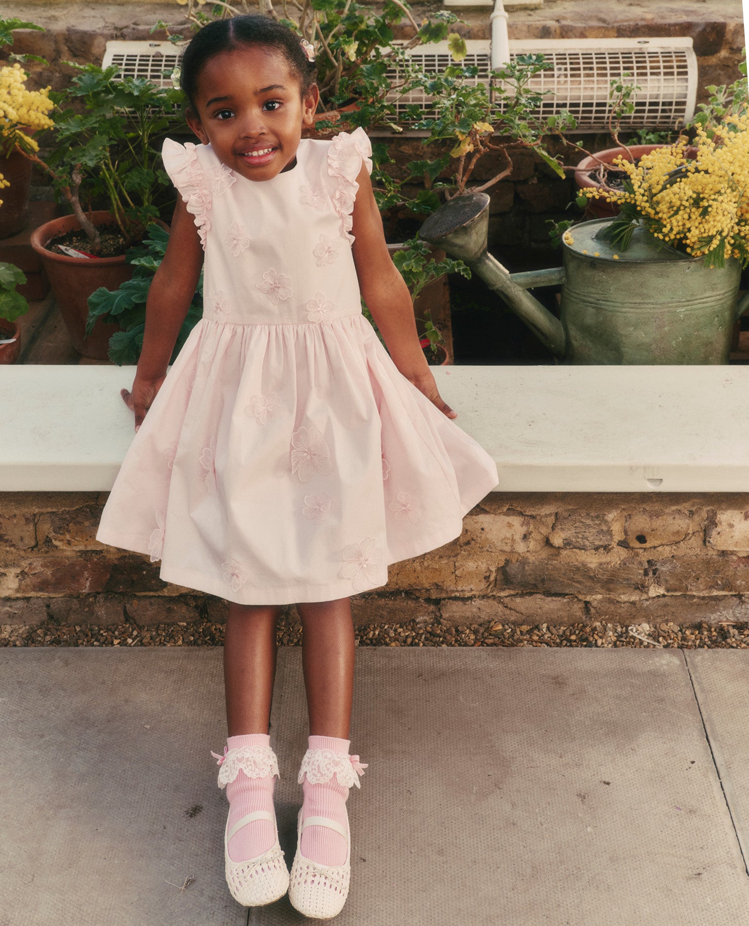 A close up of a woman wearing the Pink Cotton Flower Dress