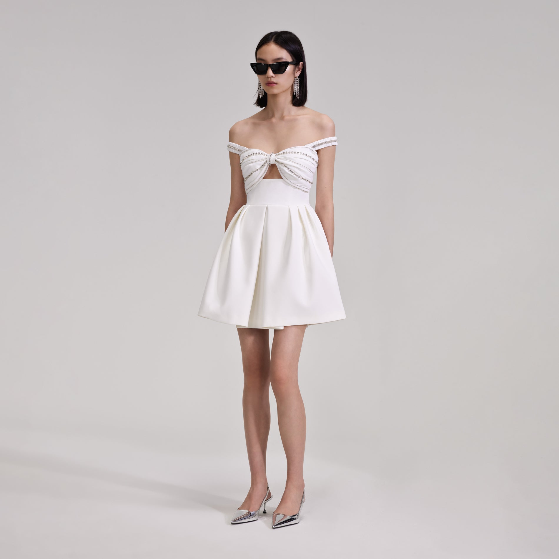 A woman wearing the White Diamante Bust Mini Dress