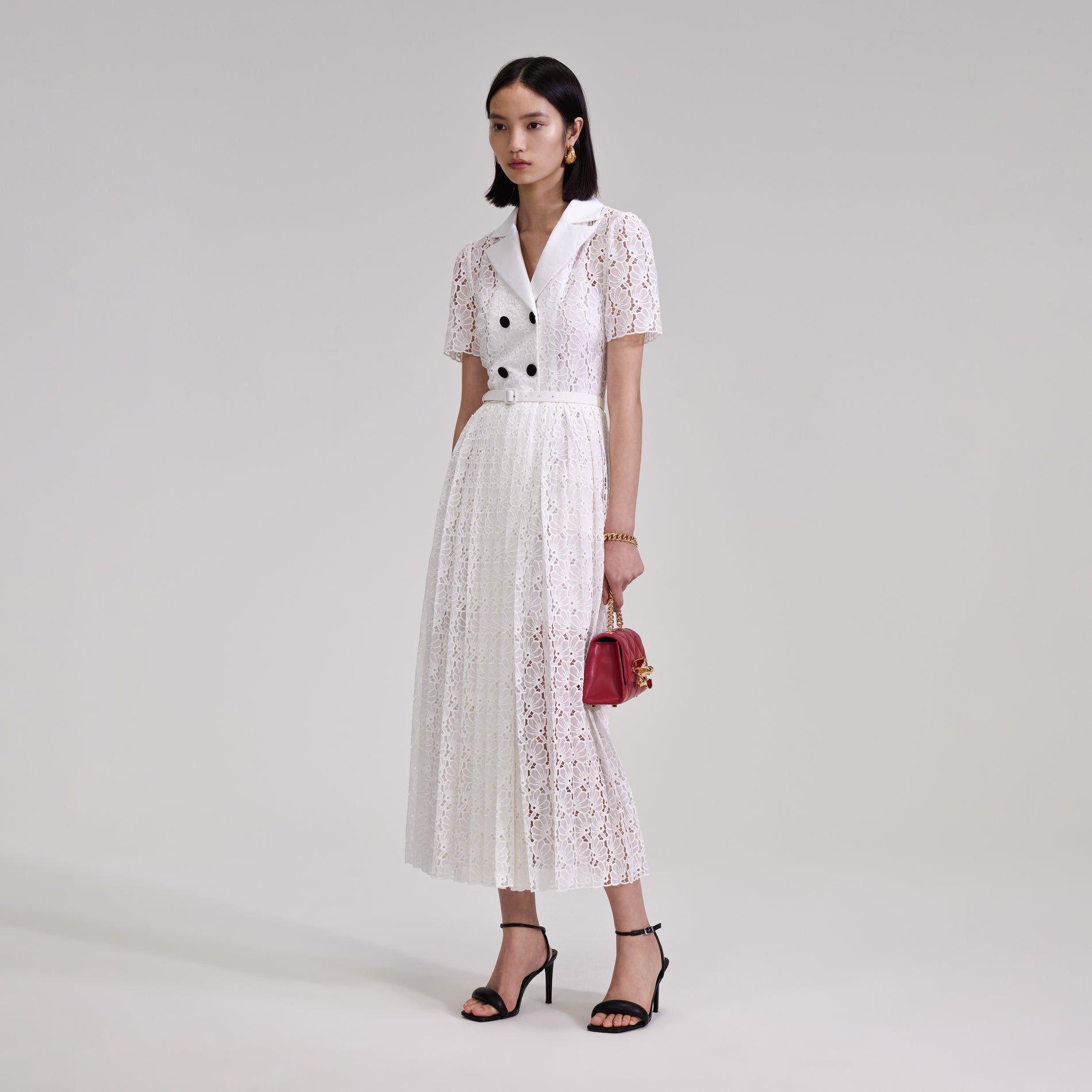 A woman wearing the White Floral Chiffon Midi Dress