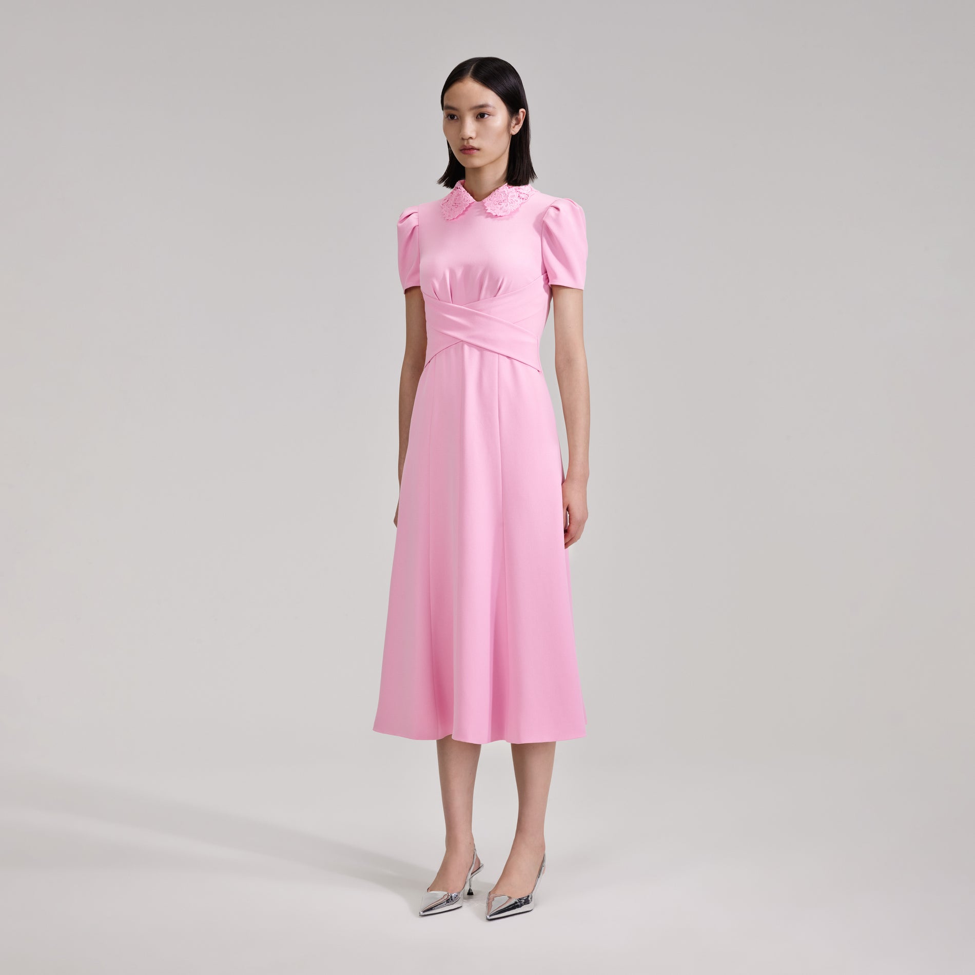 A woman wearing the Pink Heavy Crepe Midi Dress