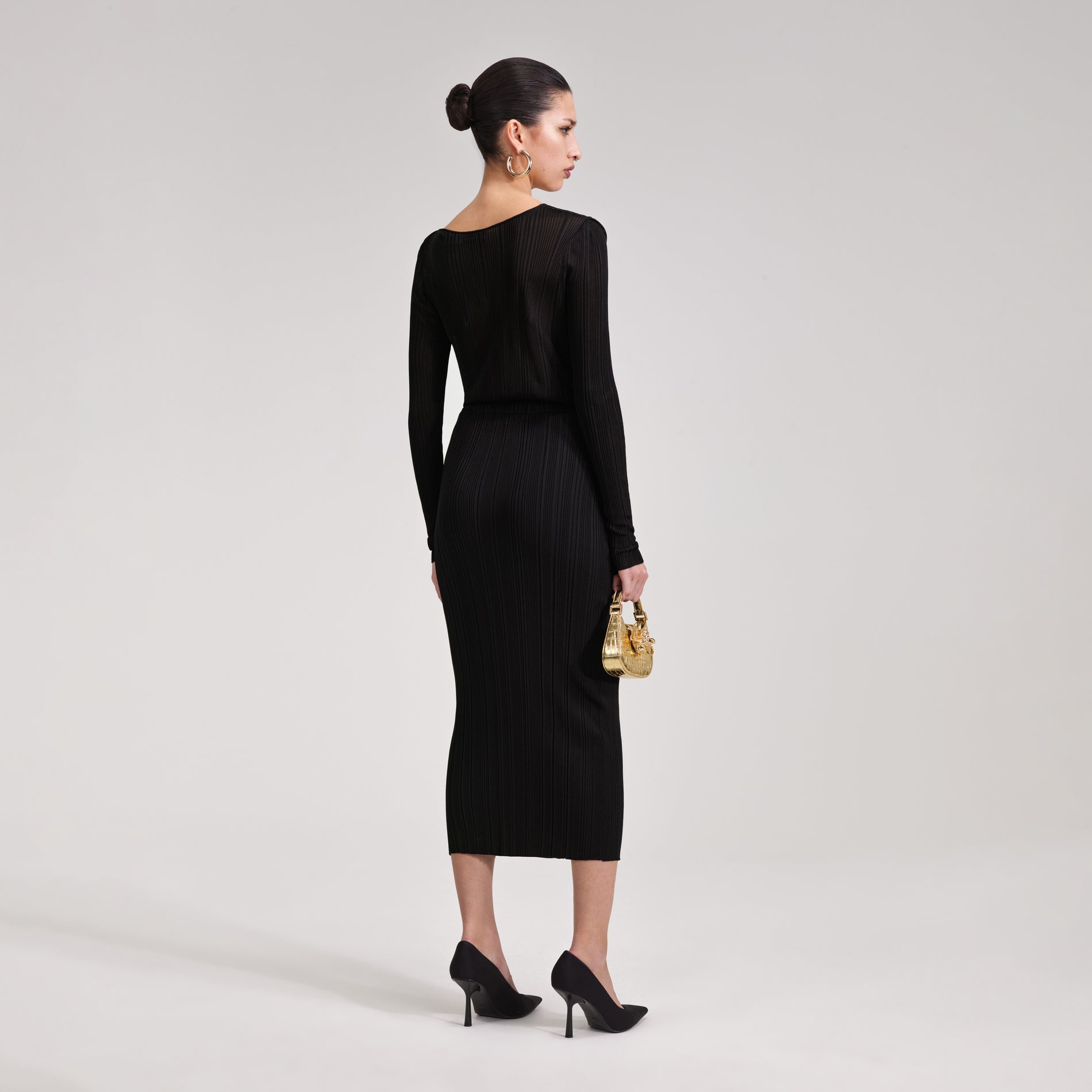A woman wearing the Black Knit Midi Dress
