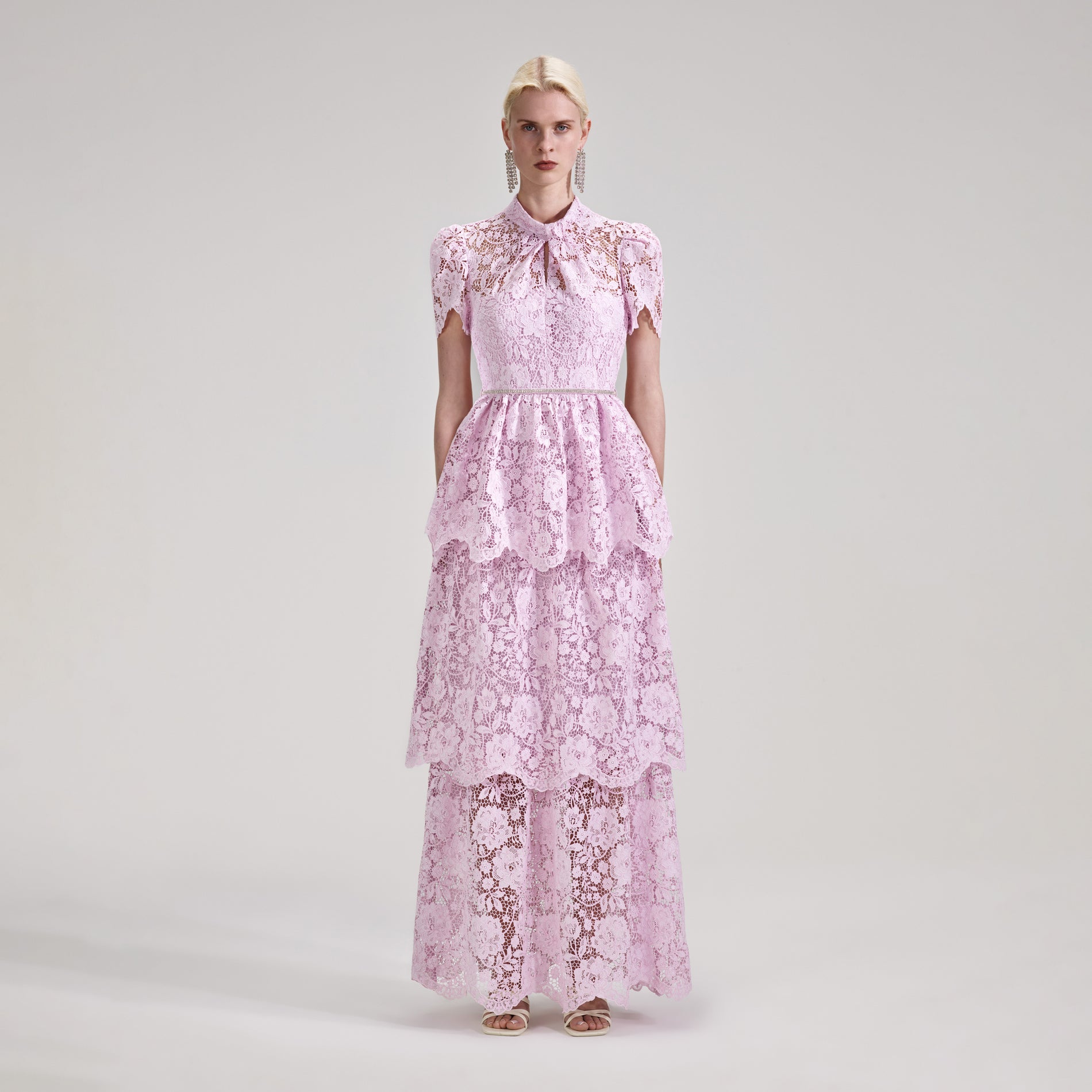 A woman wearing the Pink Cord Lace Tiered Maxi Dress