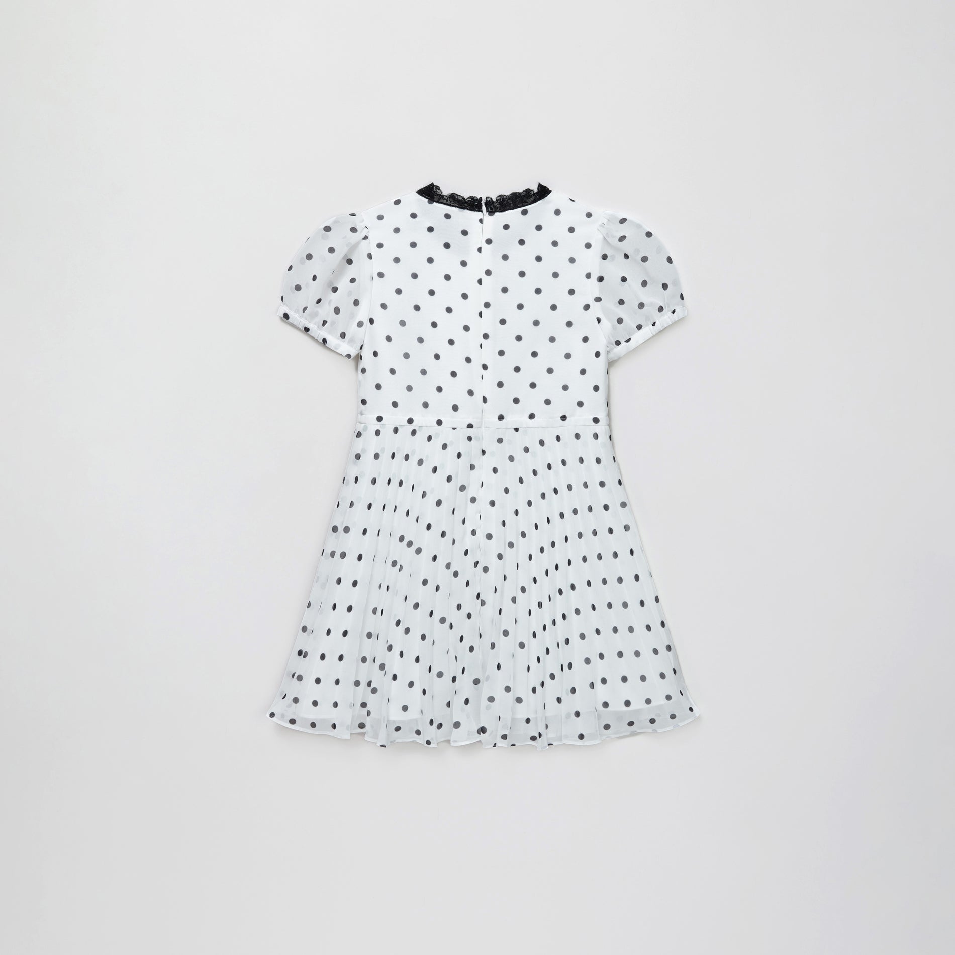 Side view of a woman wearing the Chiffon Polka Dot Dress