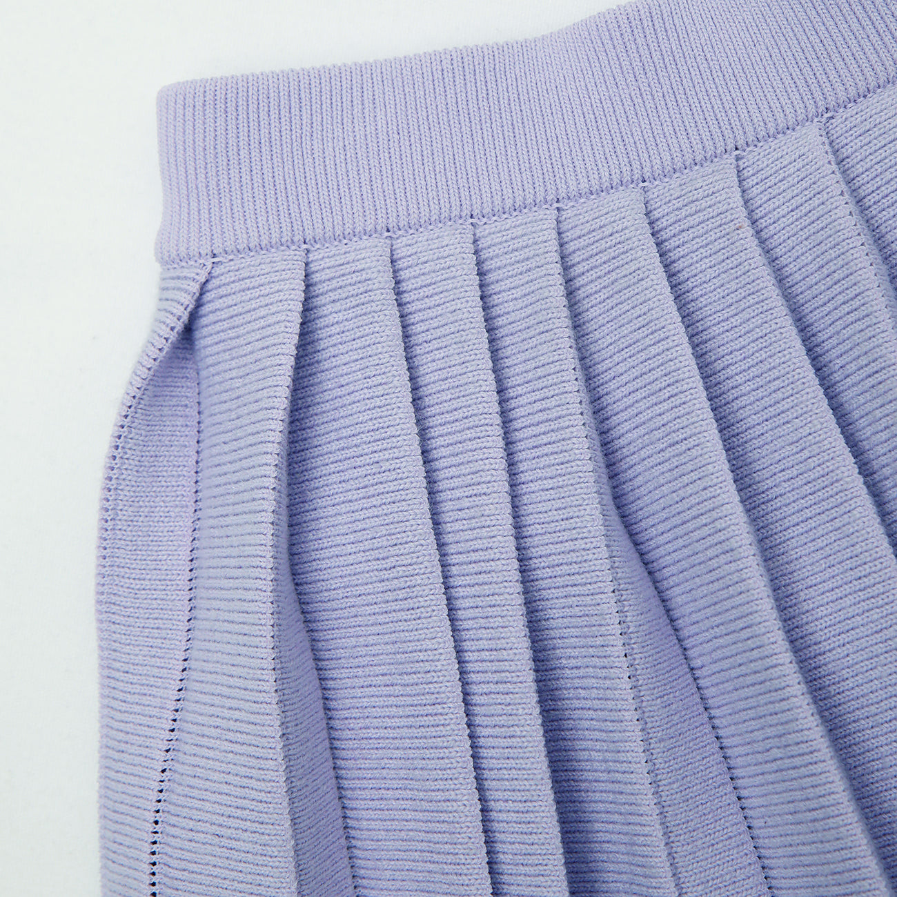 A woman wearing the Lilac Knit Pleated Skirt