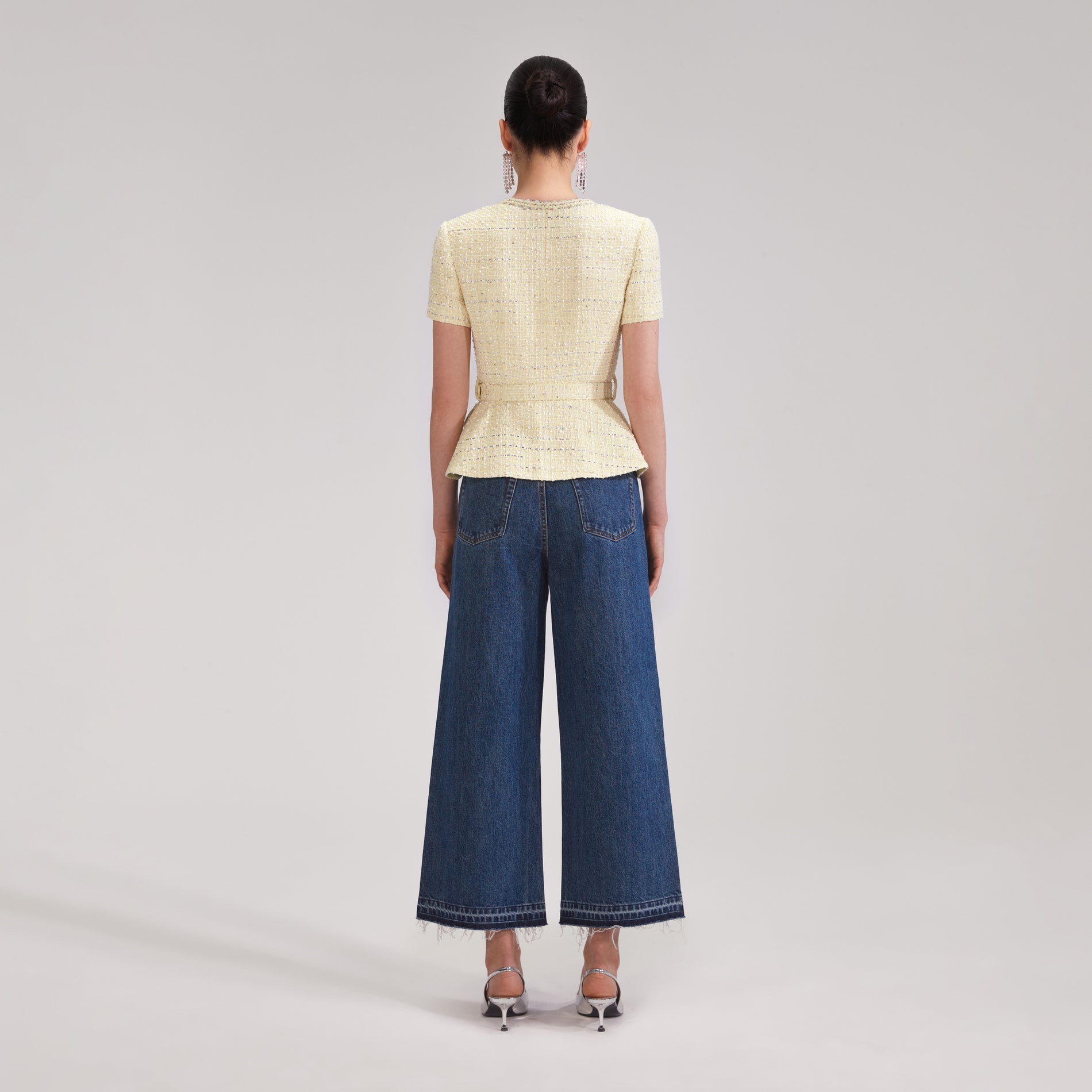 A woman wearing the Yellow Boucle Top