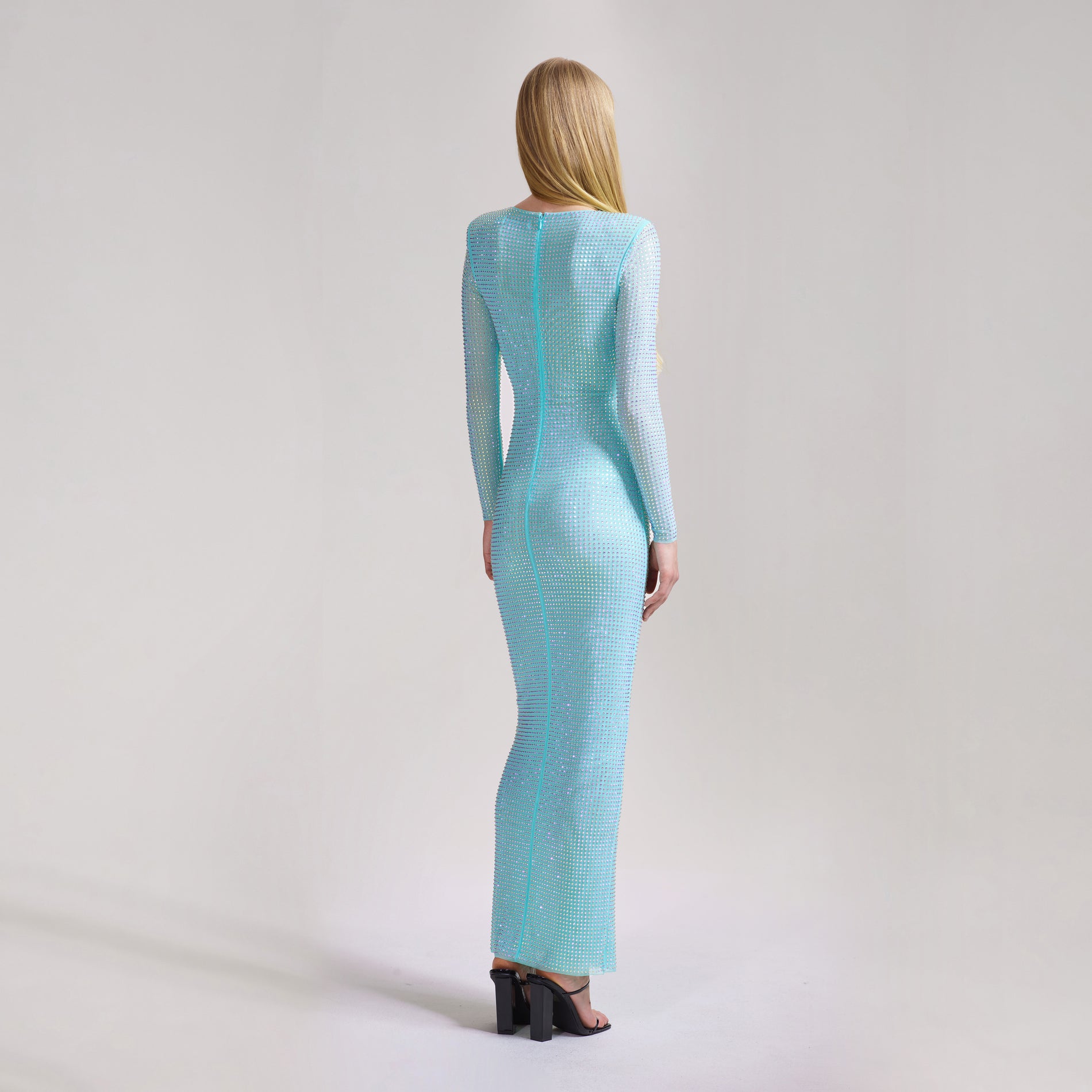 A woman wearing the Pale Blue Rhinestone Mesh Maxi Dress