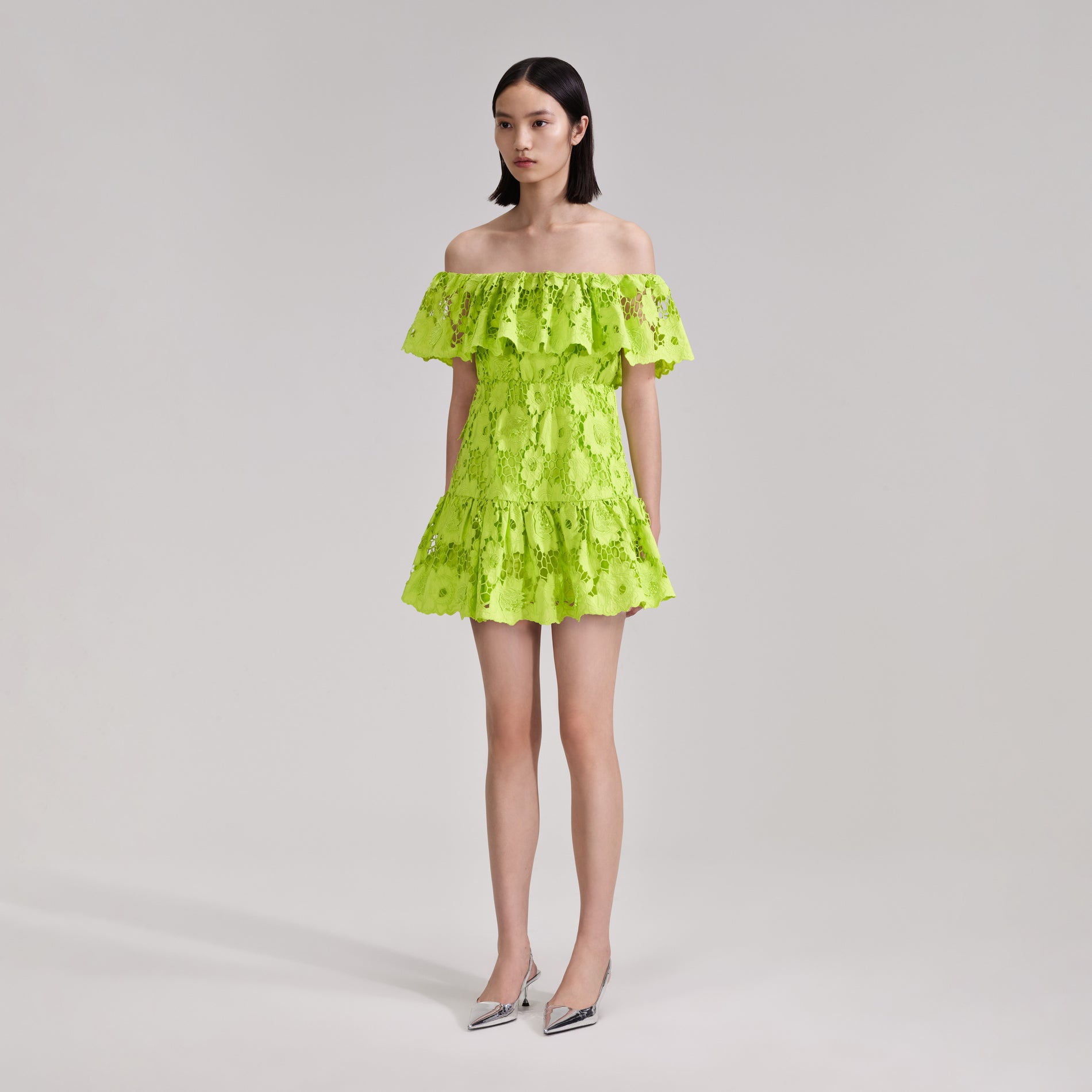 A woman wearing the Green Lace Off Shoulder Mini Dress