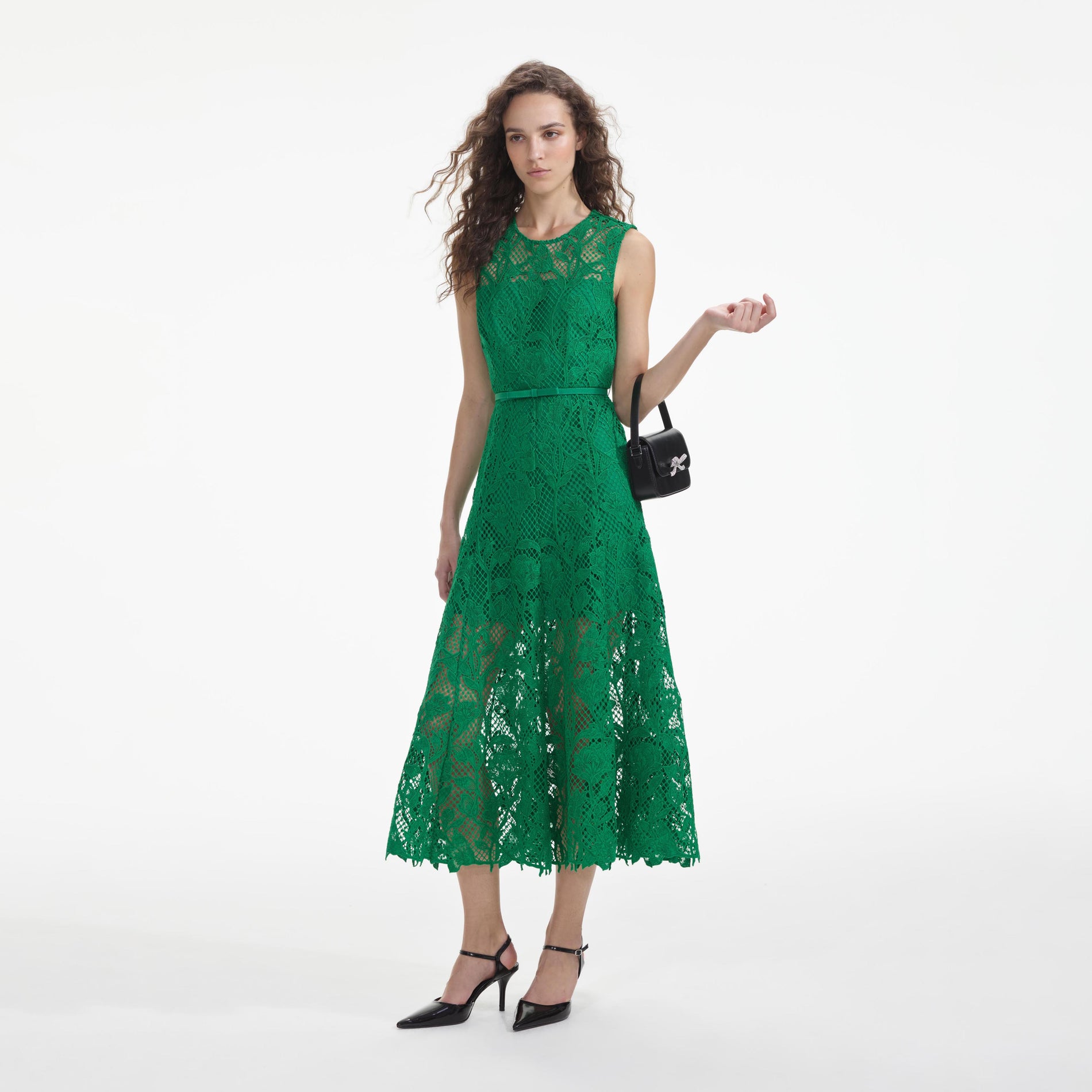 Side view of a woman wearing the Green Lace Sleeveless Midi Dress