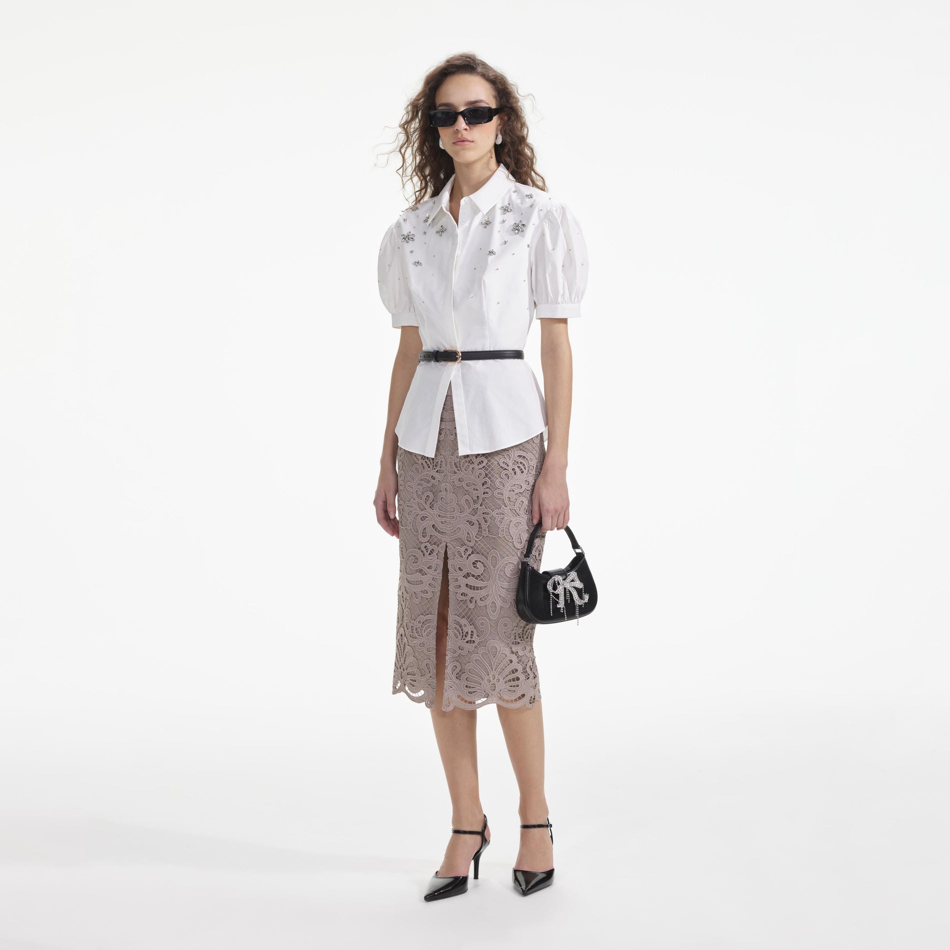 Side view of a woman wearing the White Cotton Embellished Top