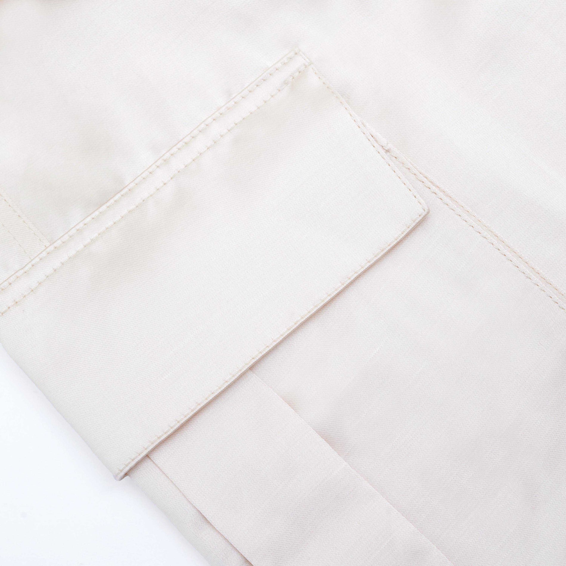 A close up of the fabric for the Cream Satin Cargo Trousers