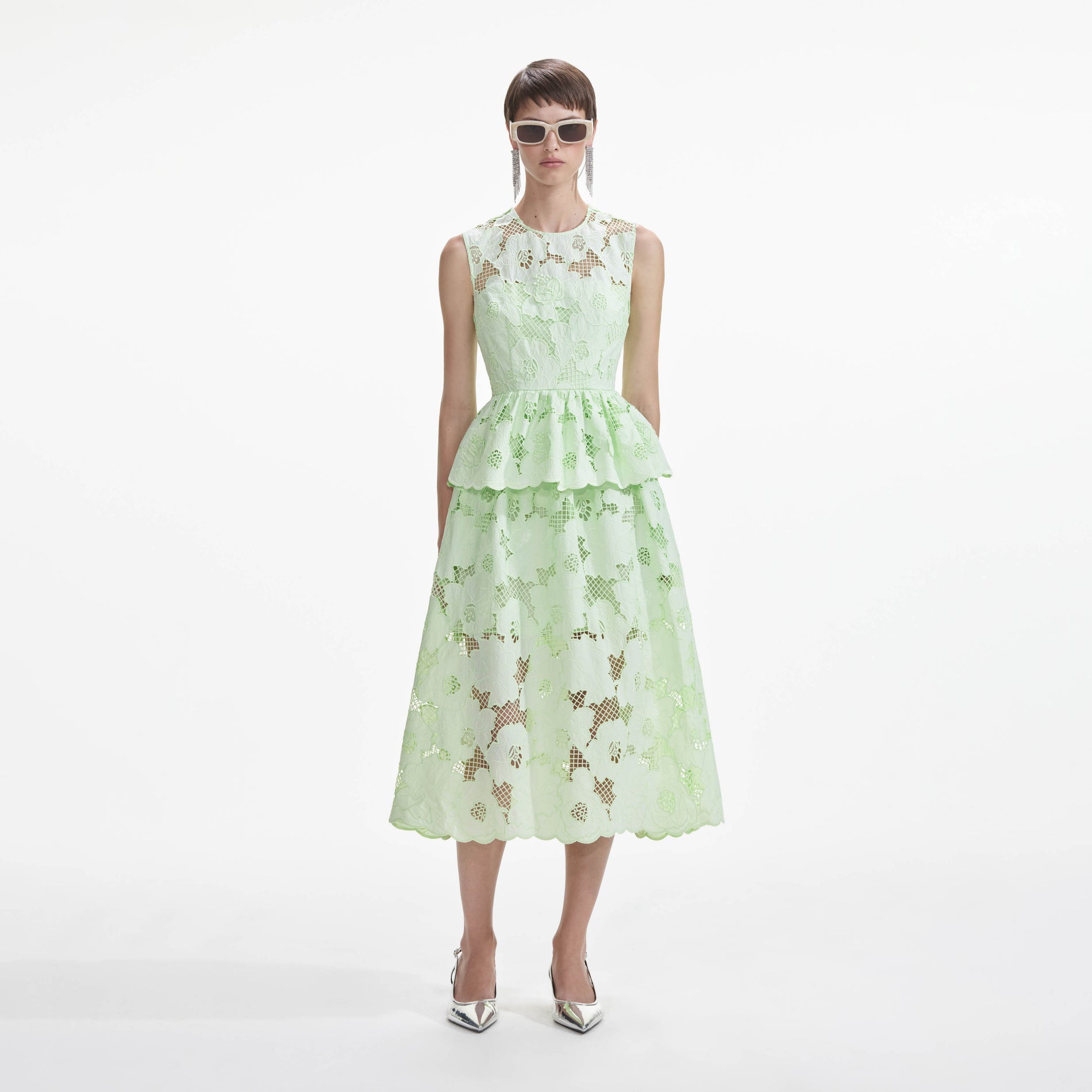 Front view of a woman wearing the Mint Cotton Lace Peplum Midi Dress