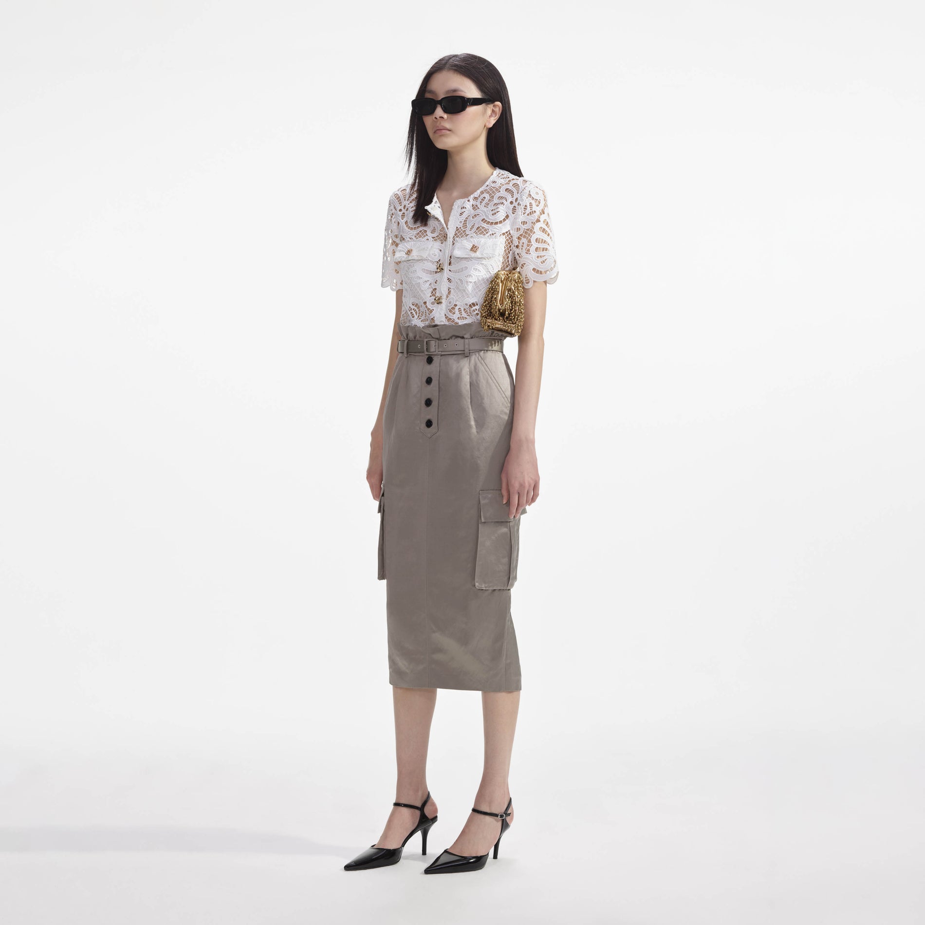 Side view of a woman wearing the White Guipure Lace Top