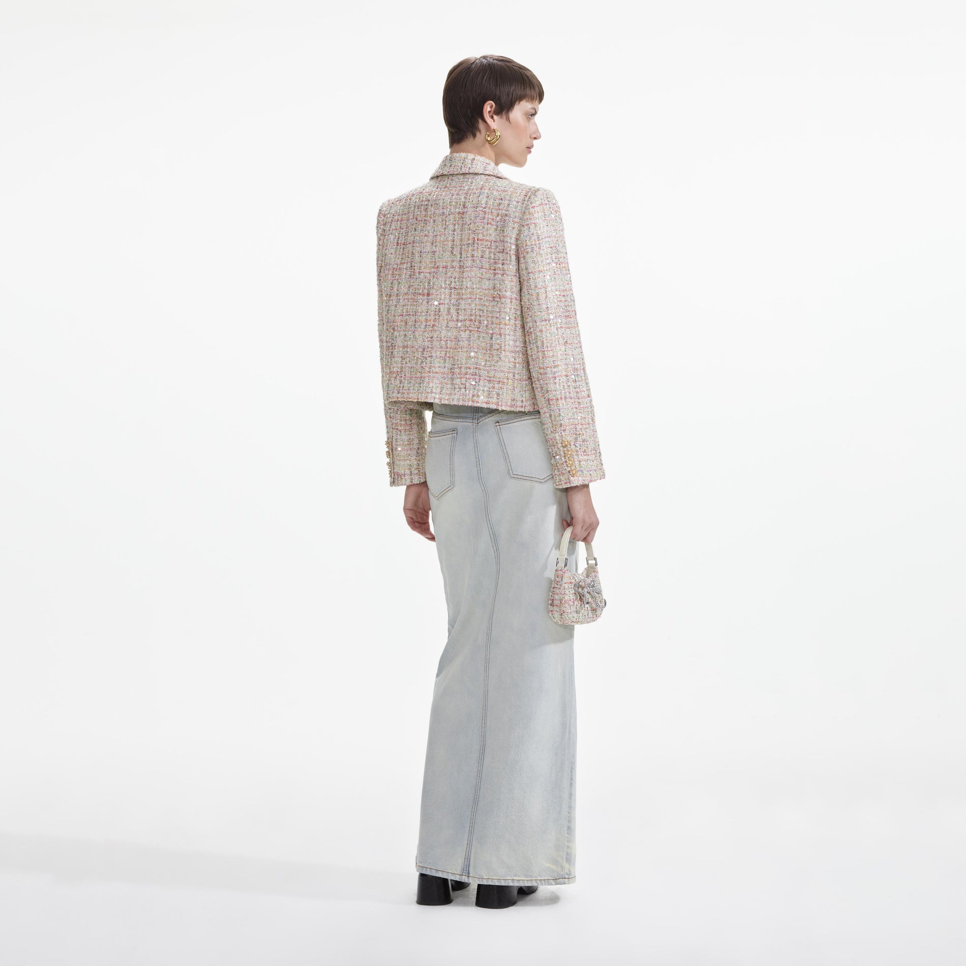Back view of a woman wearing the Pastel Boucle Jacket