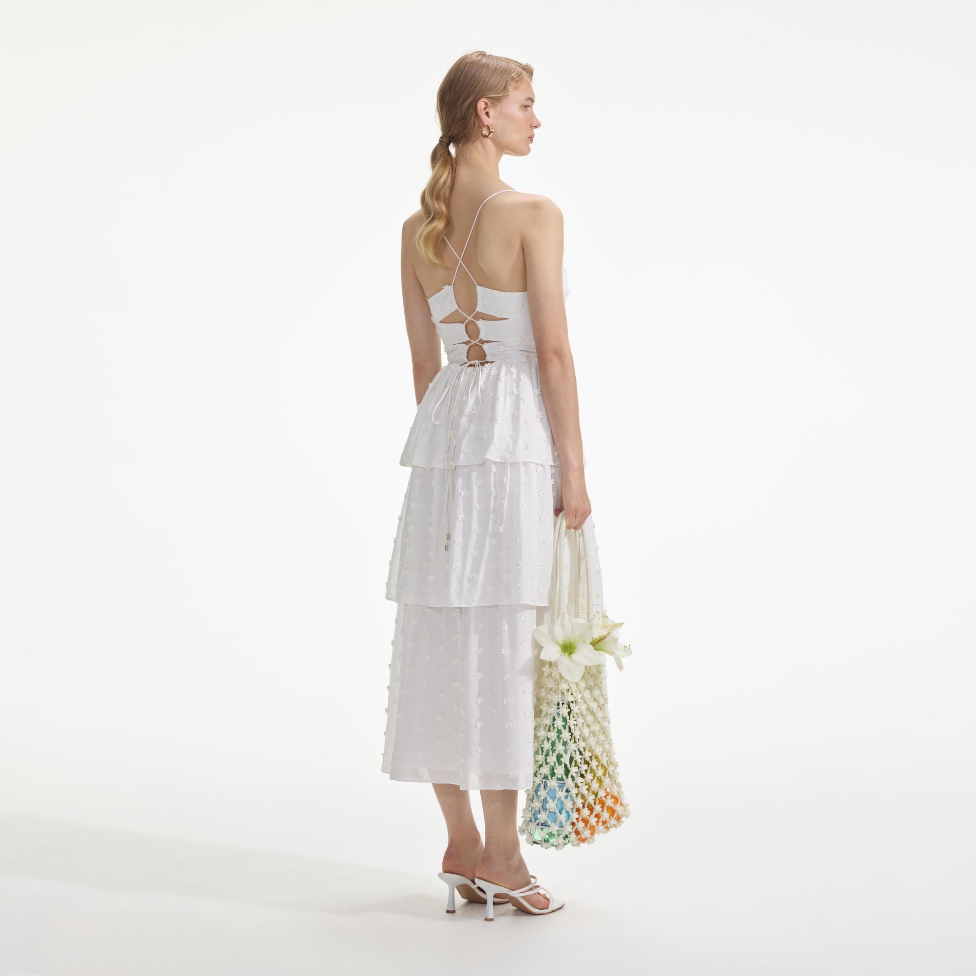 Back view of a woman wearing the White Tie Back Midi Dress