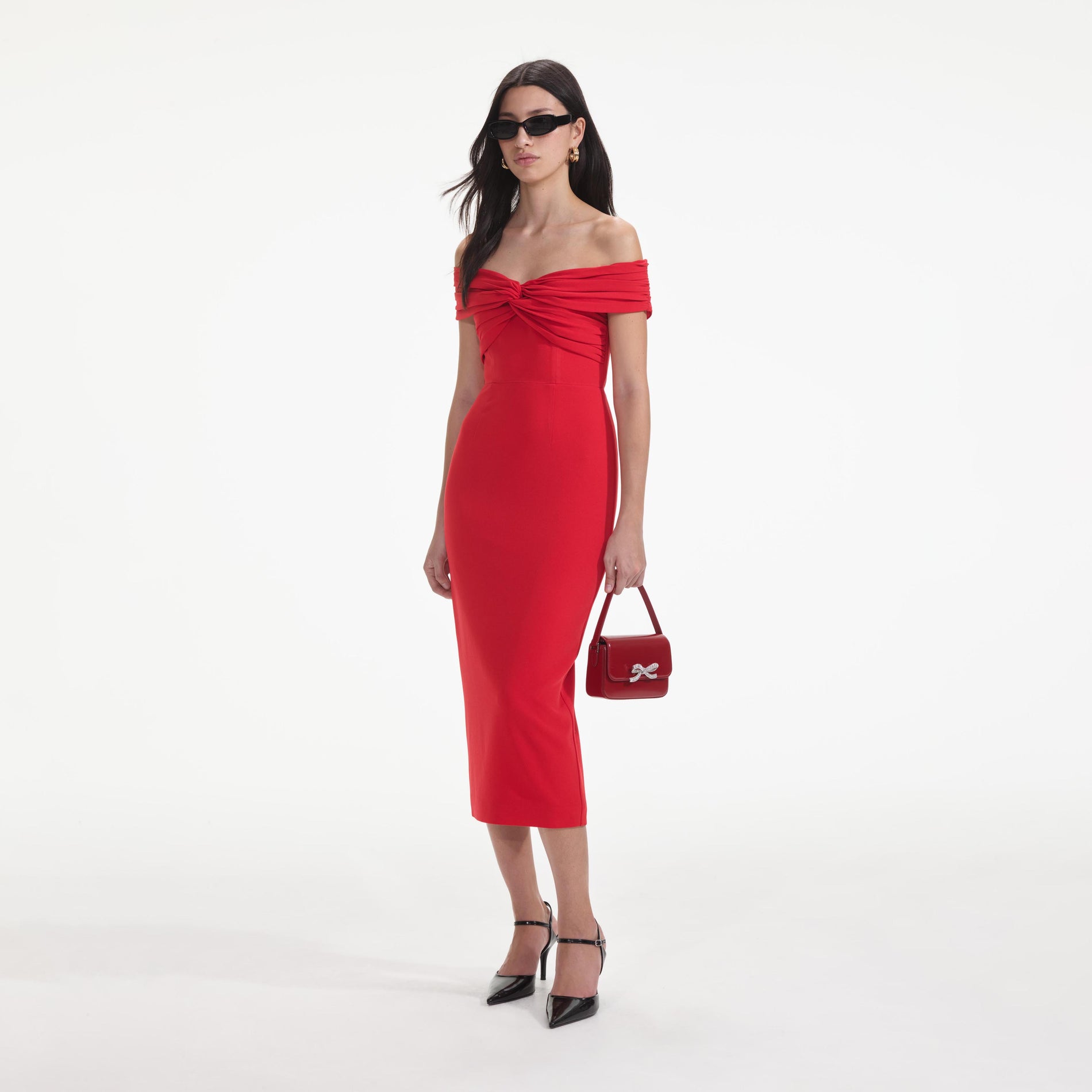 Side view of a woman wearing the Red Off Shoulder Midi Dress