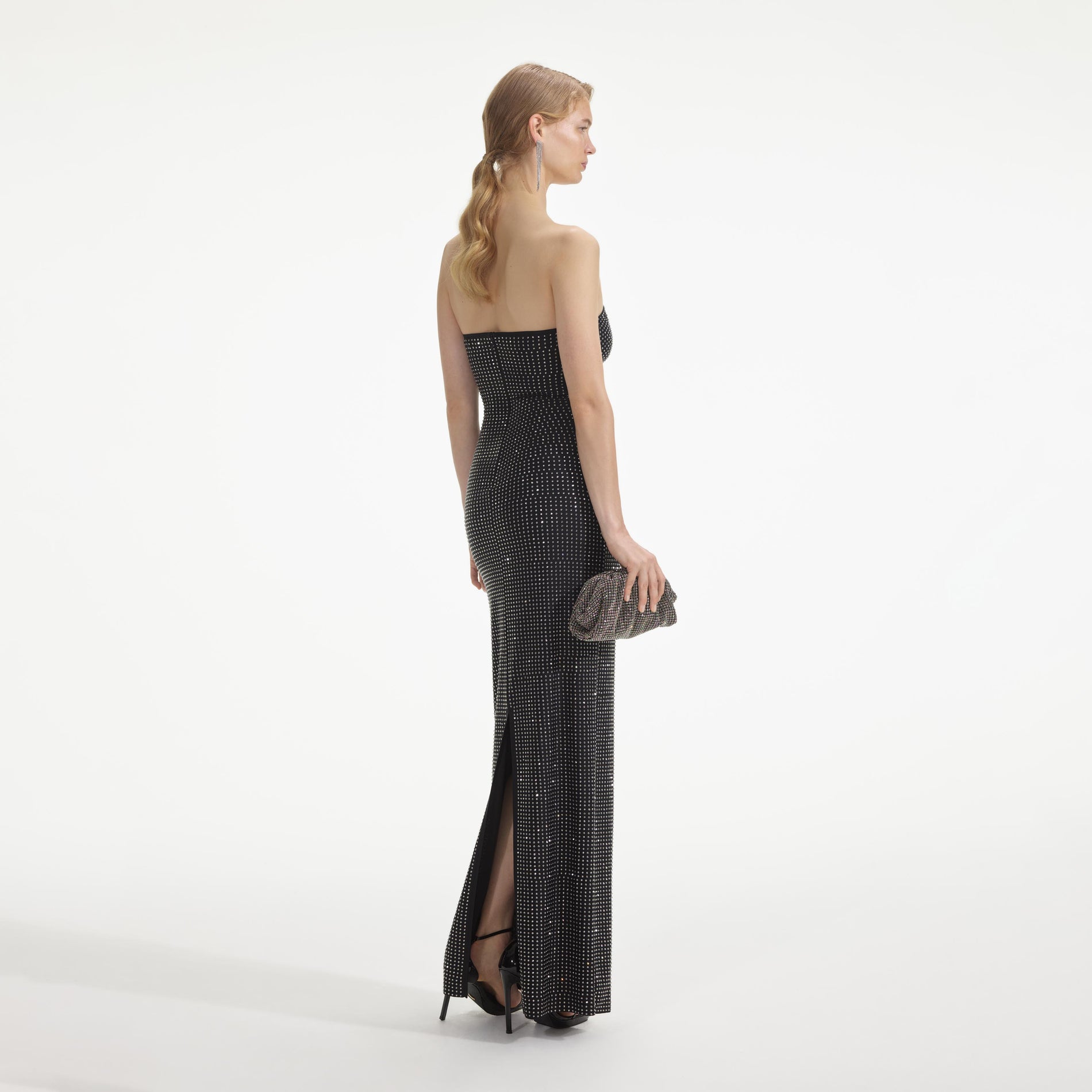 Back view of a woman wearing the Black Jersey Rhinestone Maxi Dress