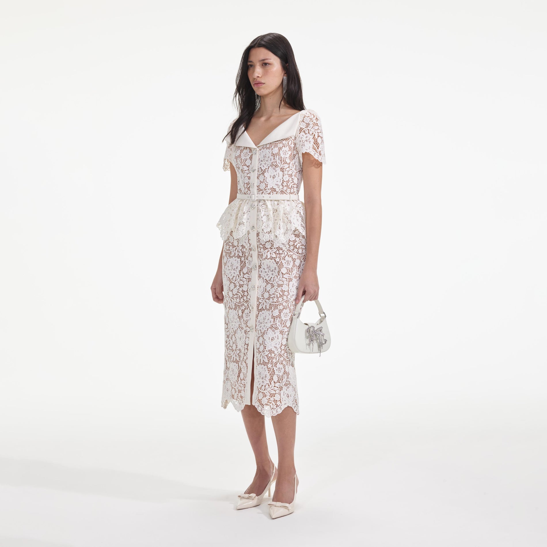 Side view of a woman wearing the Cream Lace Peplum Midi Dress