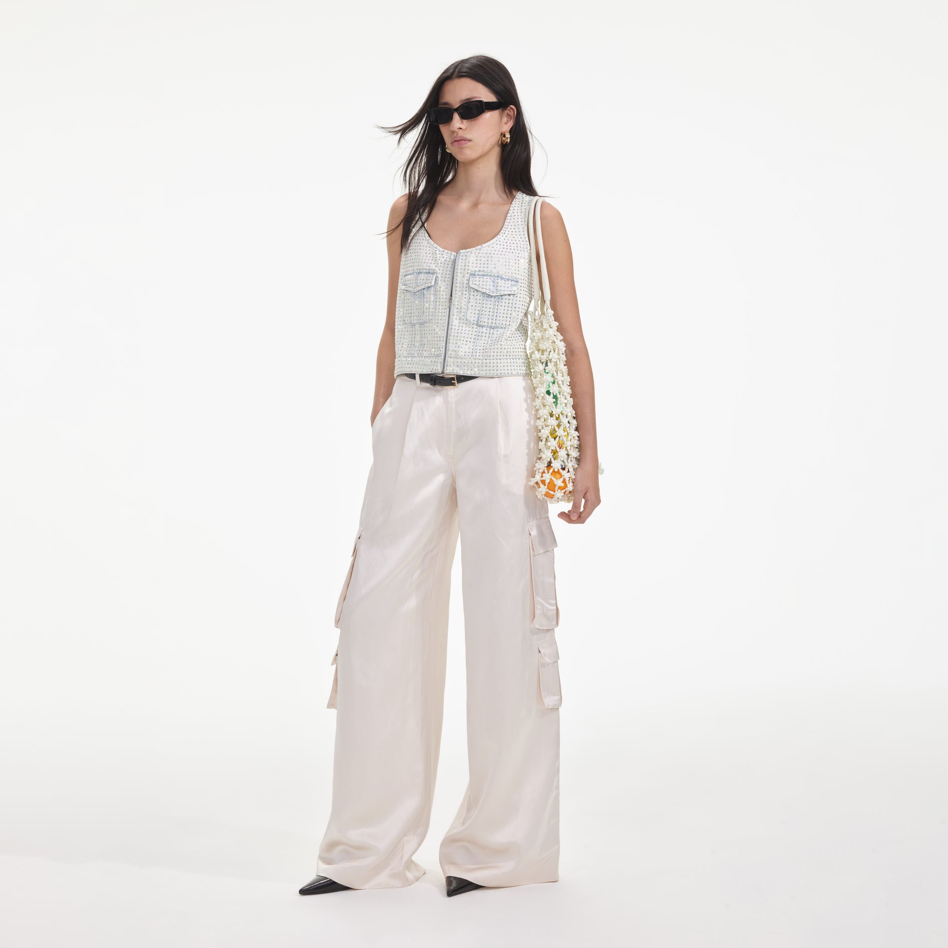 Side view of a woman wearing the Cream Satin Cargo Trousers