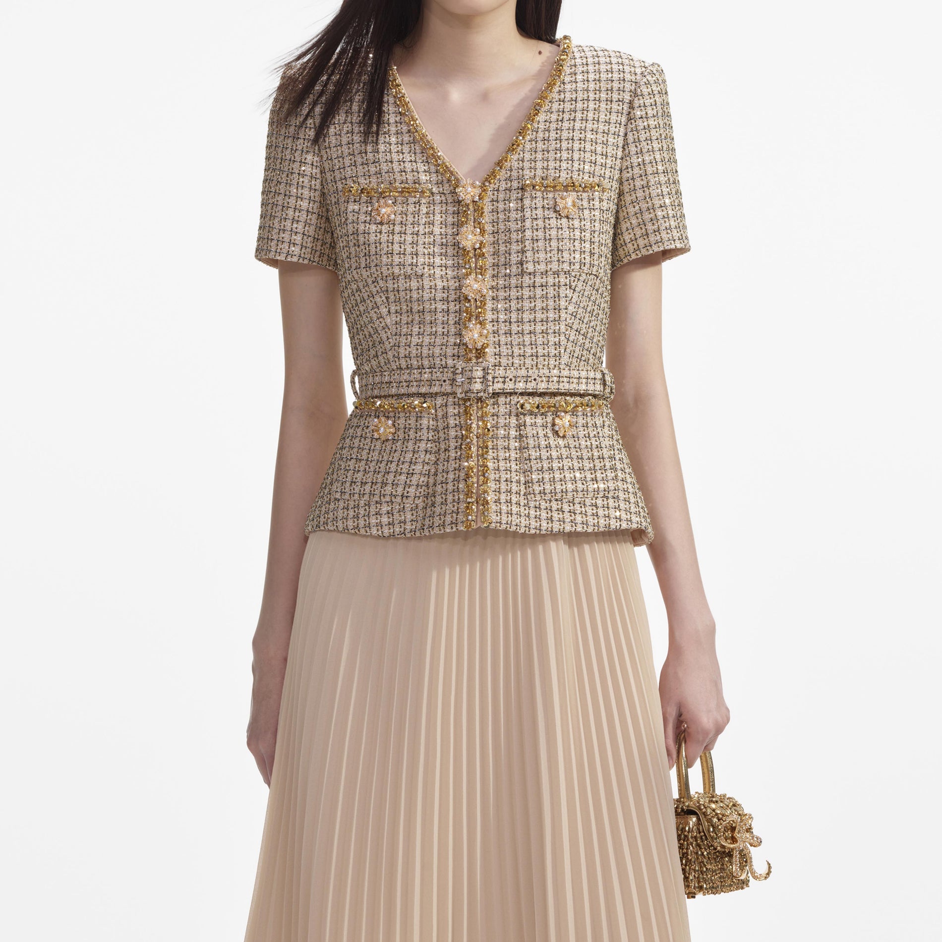 A close up of a woman wearing the Gold Boucle Midi Dress