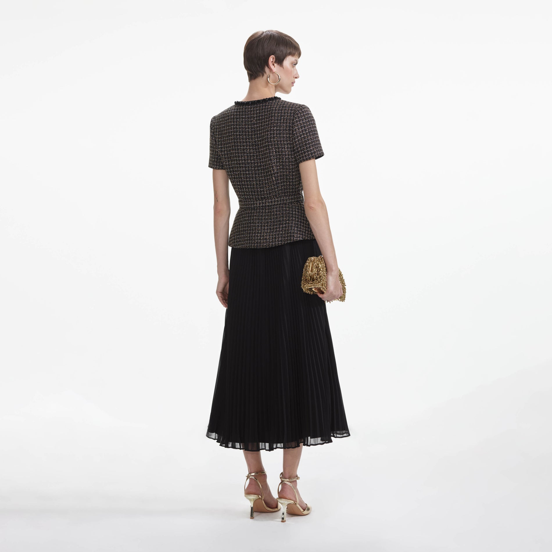 Back view of a woman wearing the Black Boucle Chiffon Midi Dress