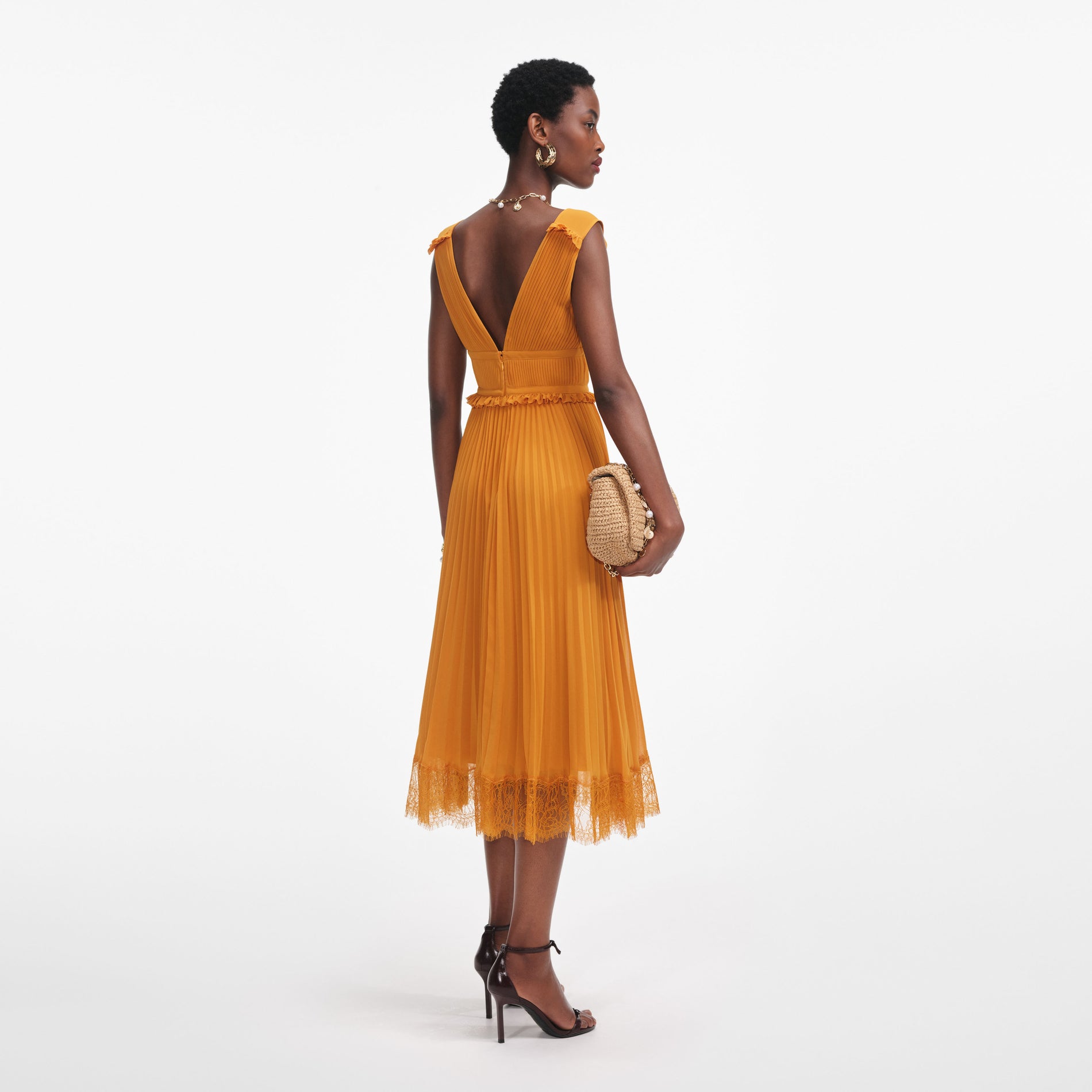 Back view of a woman wearing the Burnt Orange Chiffon Midi Dress