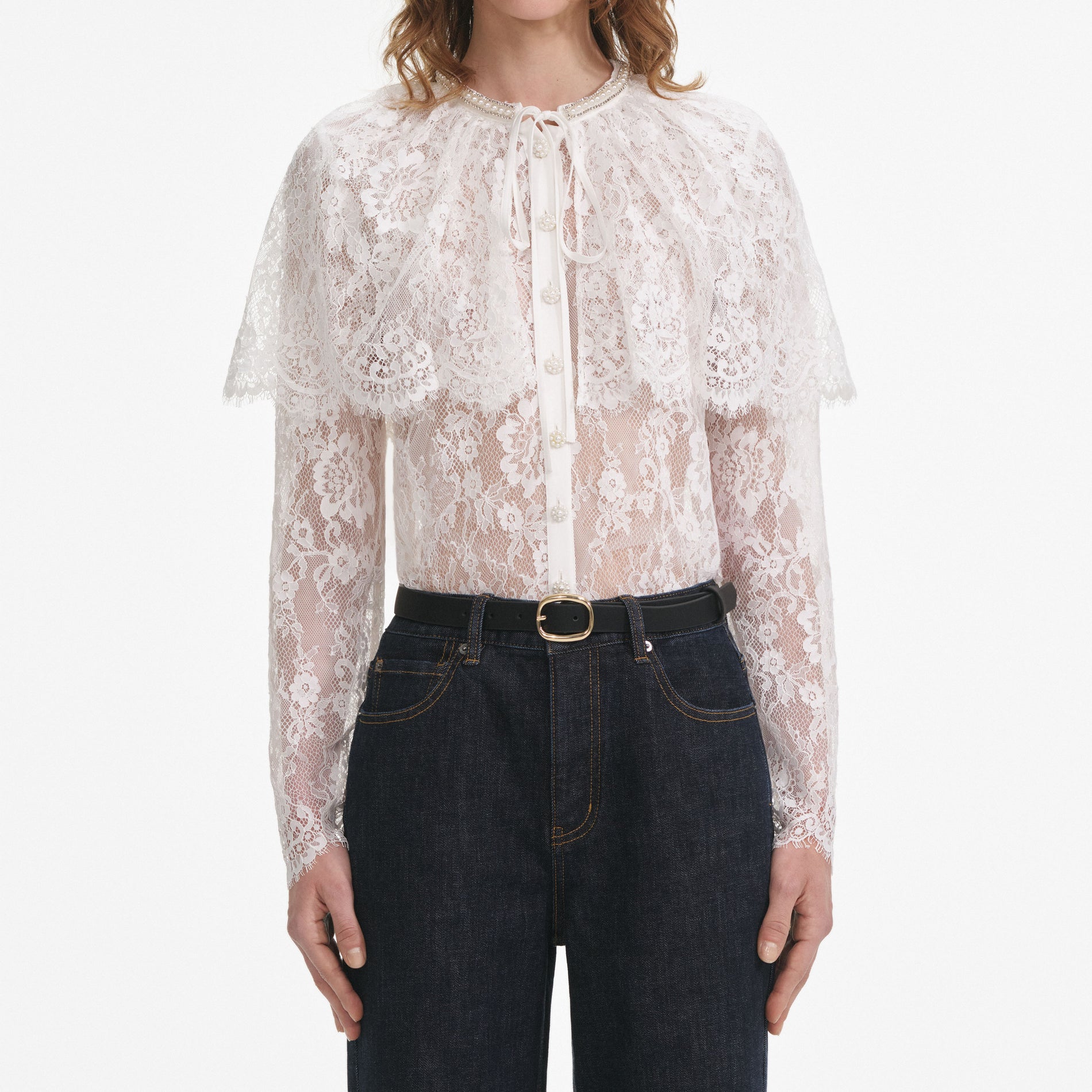 A close up of a woman wearing the White Lace Cape Top