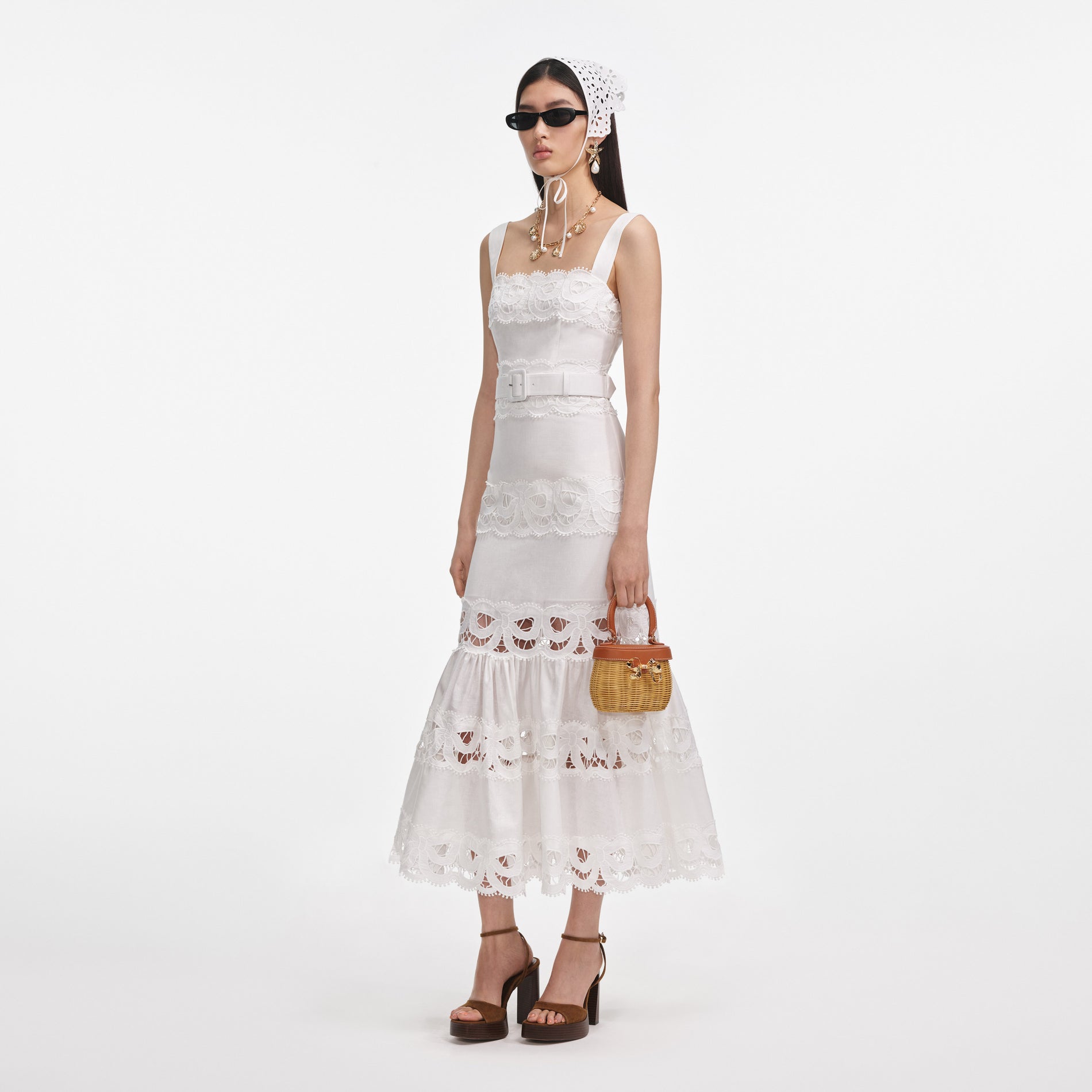 Side view of a woman wearing the White Linen Lace Insert Midi Dress