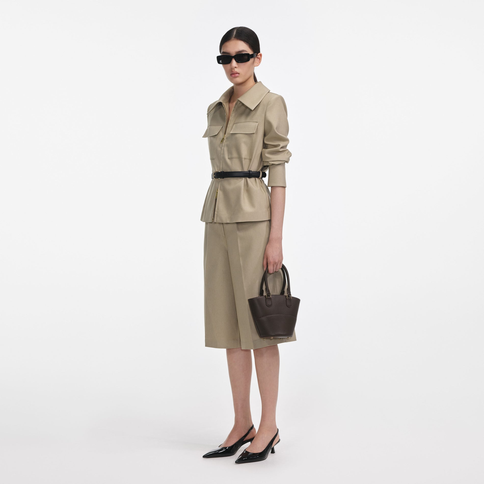 Side view of a woman wearing the Beige Twill Playsuit