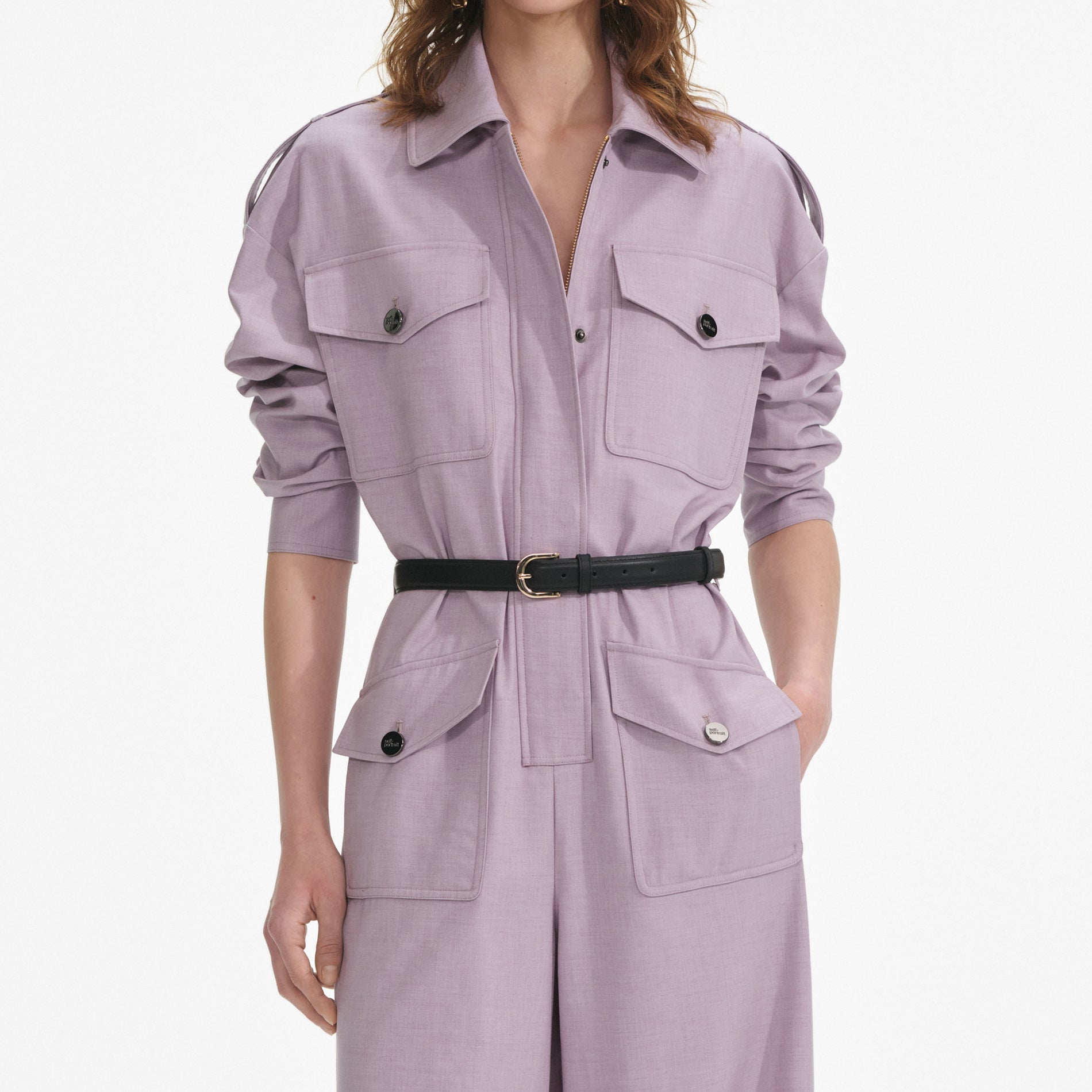 A close up of a woman wearing the Lilac Twill Jumpsuit