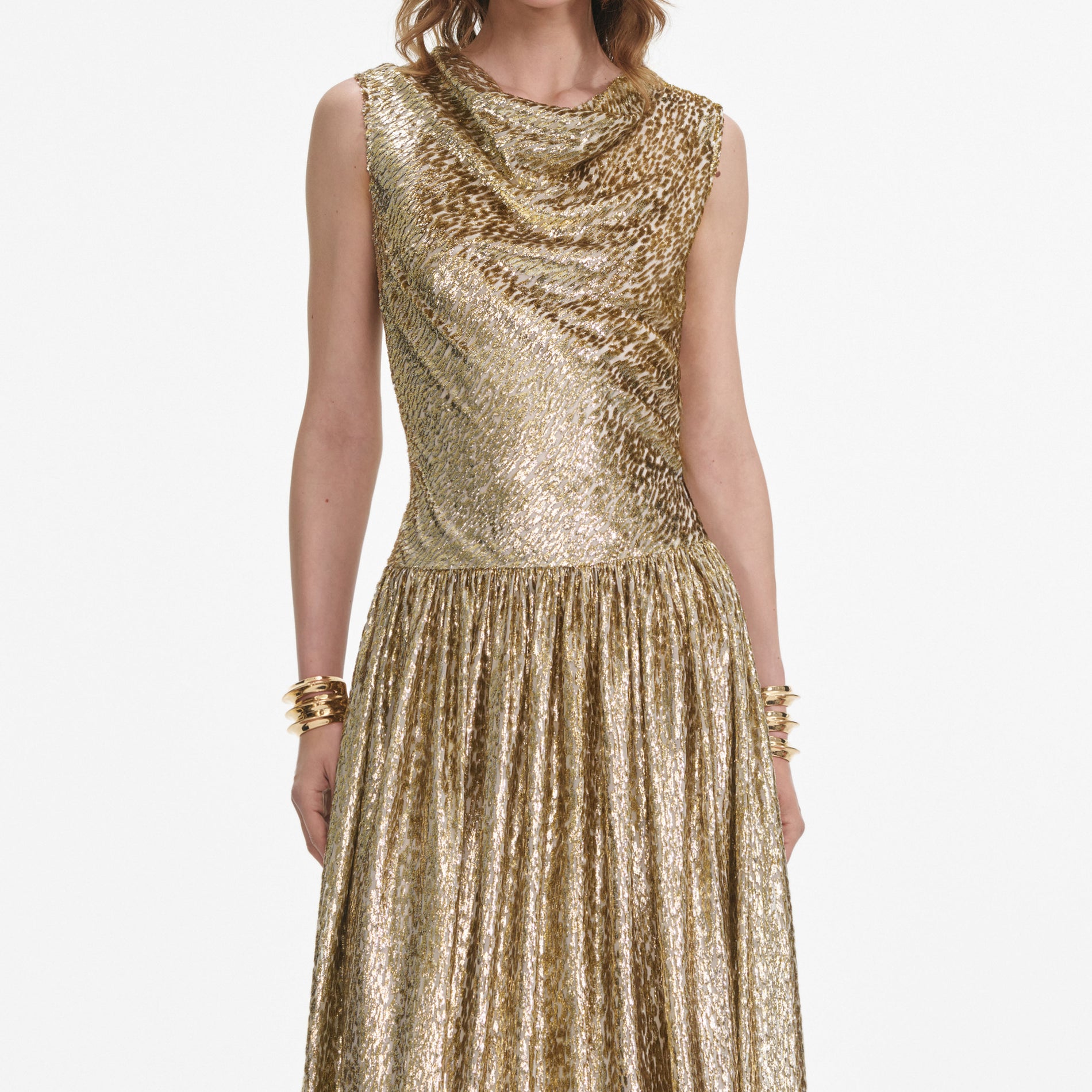 A close up of a woman wearing the Gold Sleeveless Fil Coupe Maxi Dress