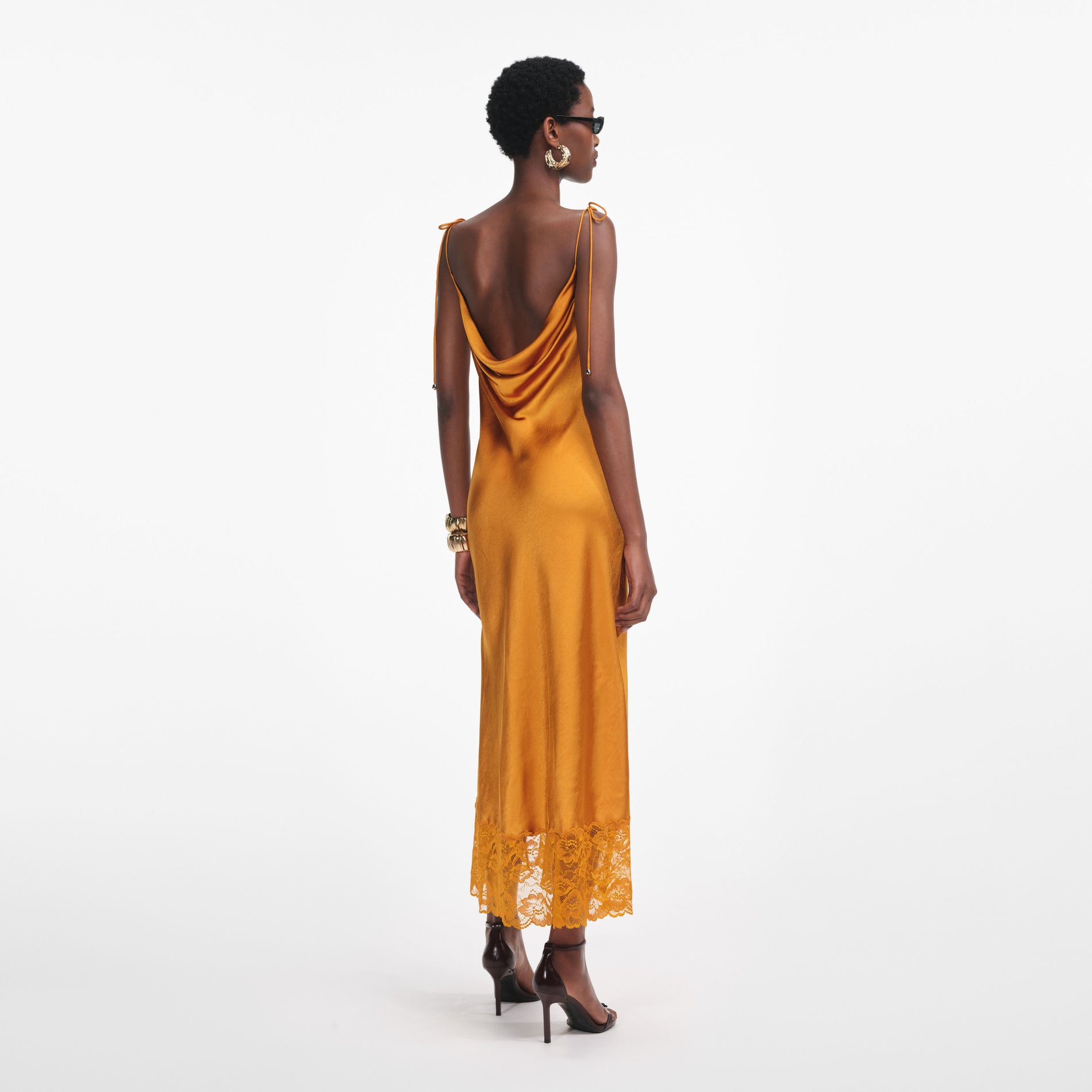 Back view of a woman wearing the Burnt Orange Satin Midi Dress