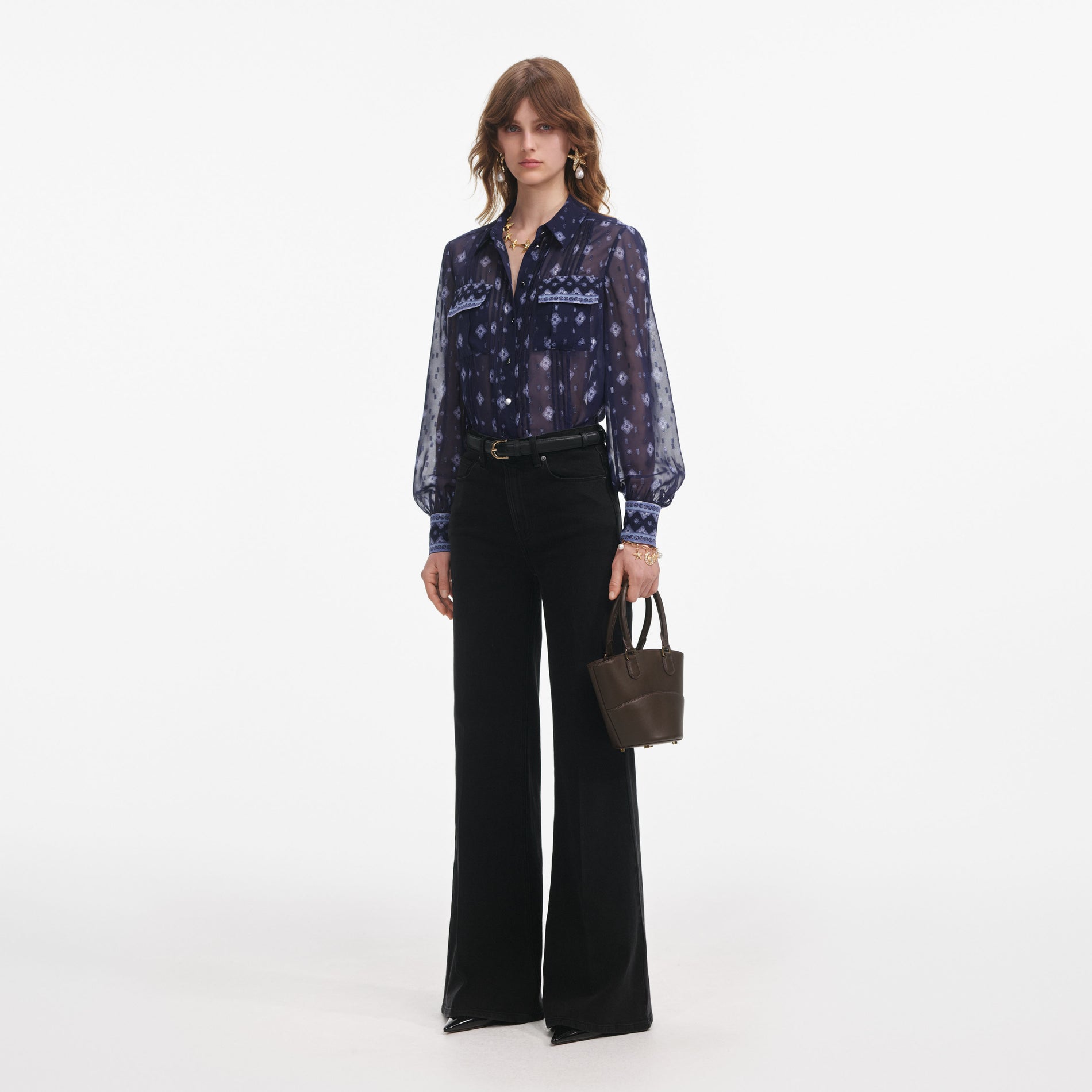 Side view of a woman wearing the Navy Printed Chiffon Blouse