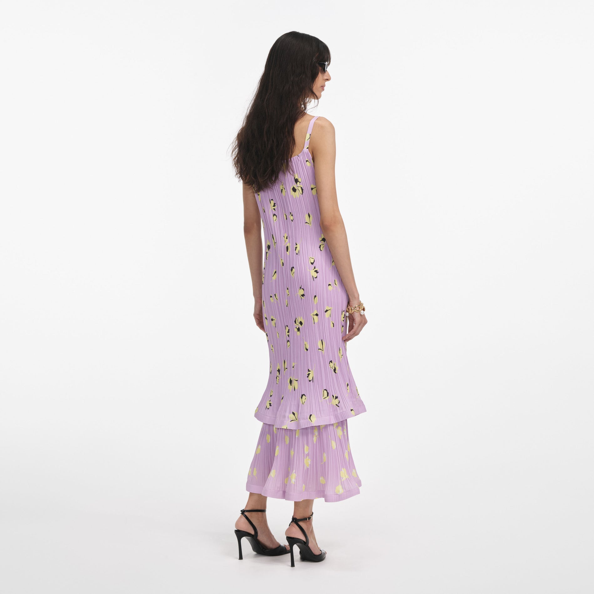 Back view of a woman wearing the Lilac Floral Plisse Midi Dress