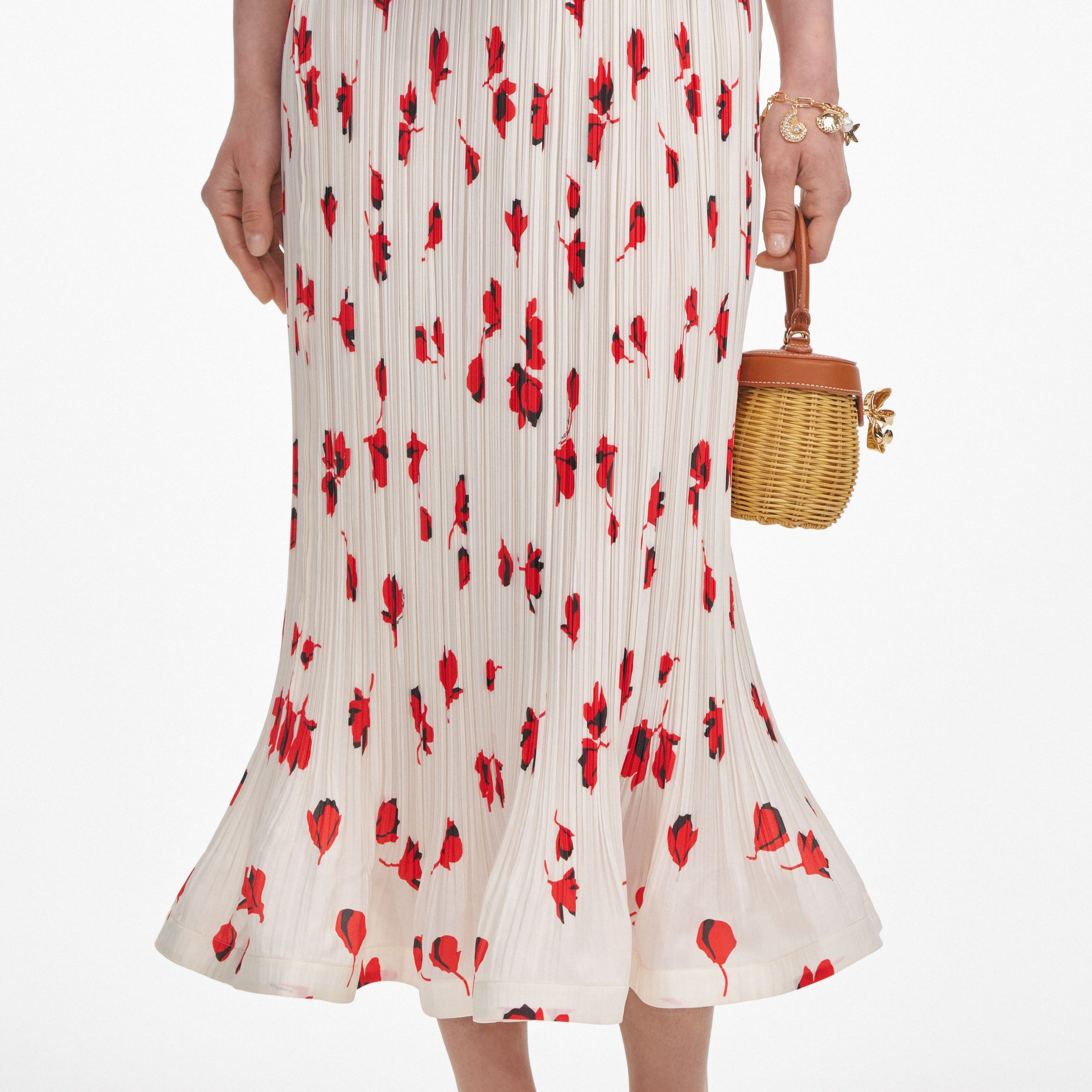 A close up of a woman wearing the White Floral Plisse  Midi Skirt