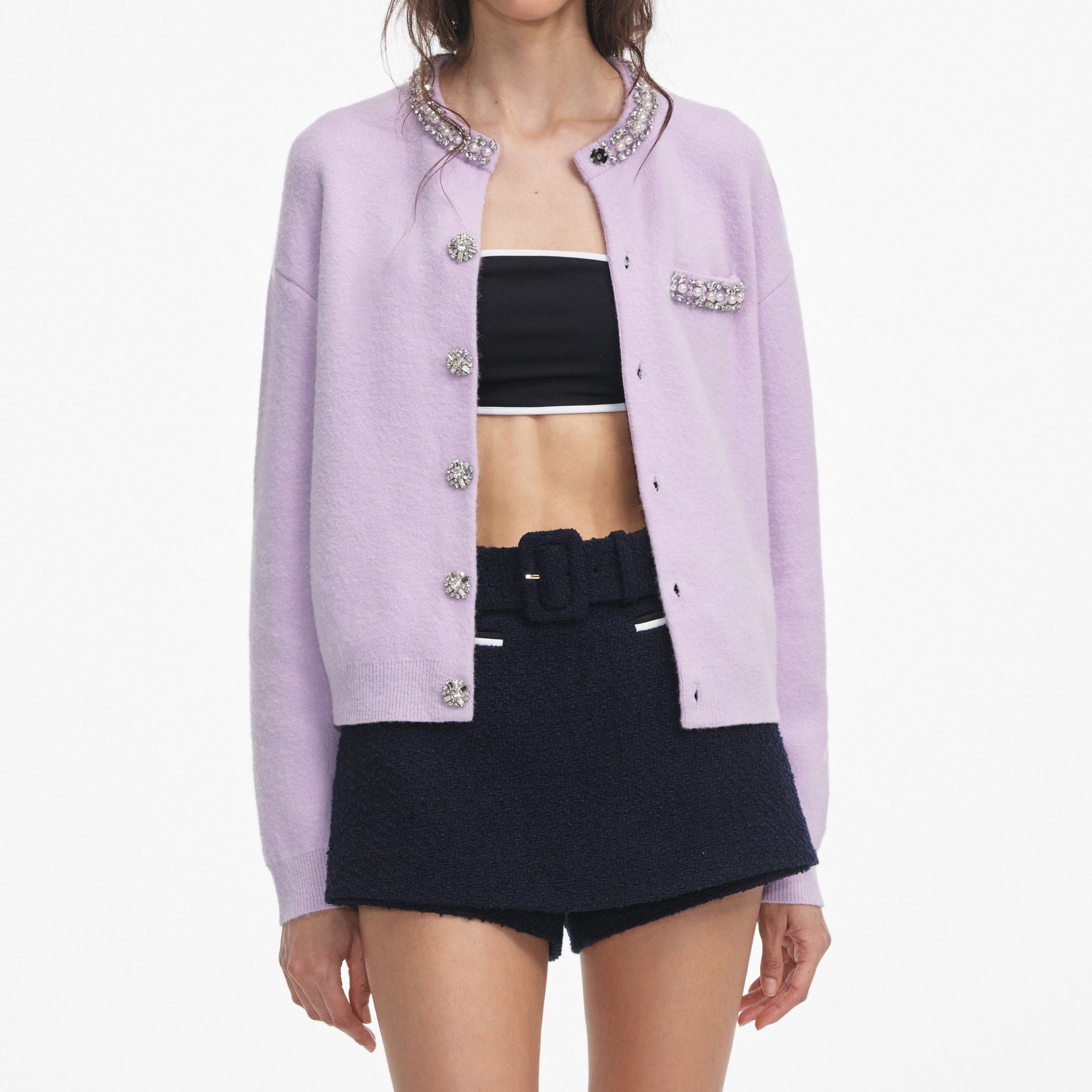 A close up of a woman wearing the Lilac Crystal Trim Cardigan