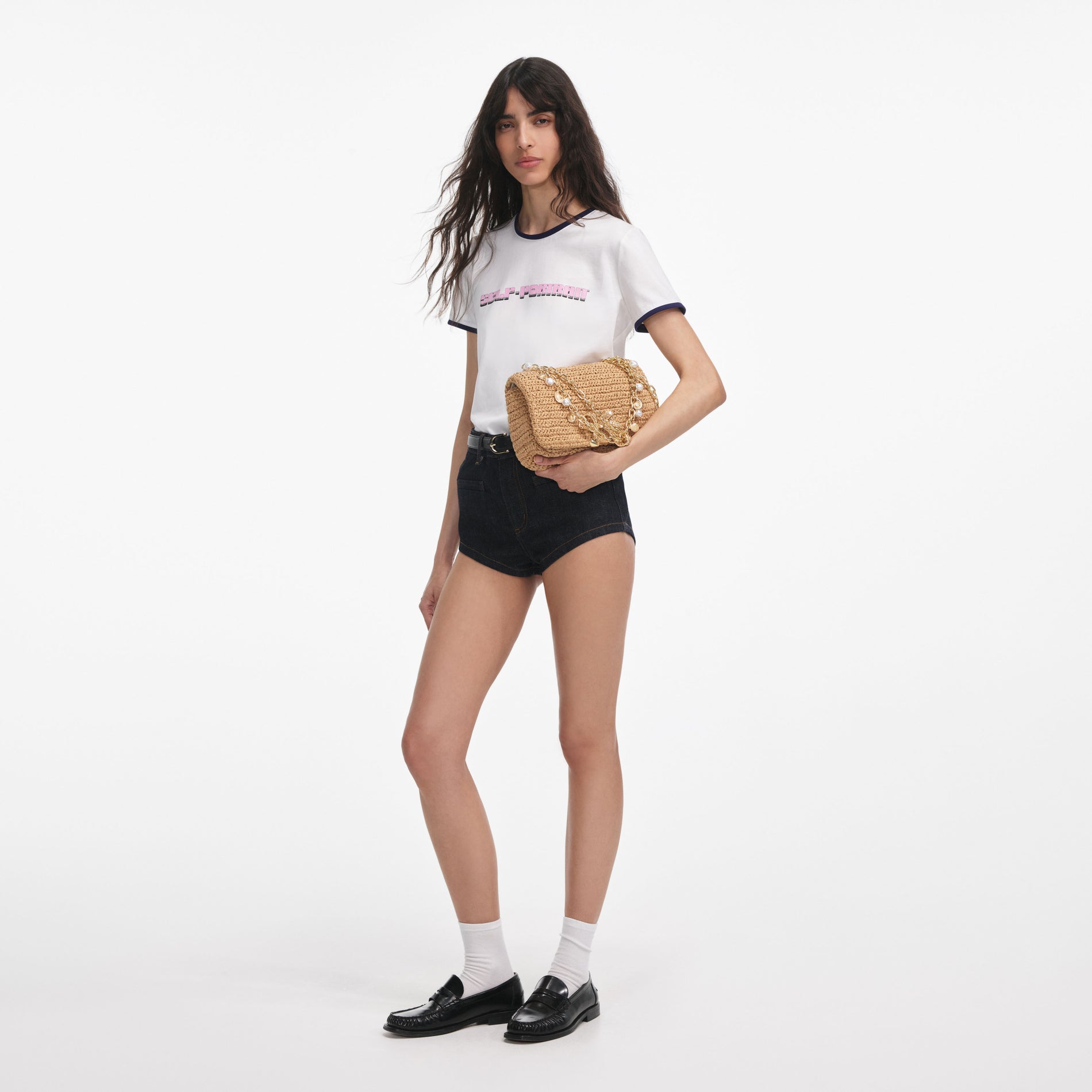 Side view of a woman wearing the White T-Shirt With Pink Logo