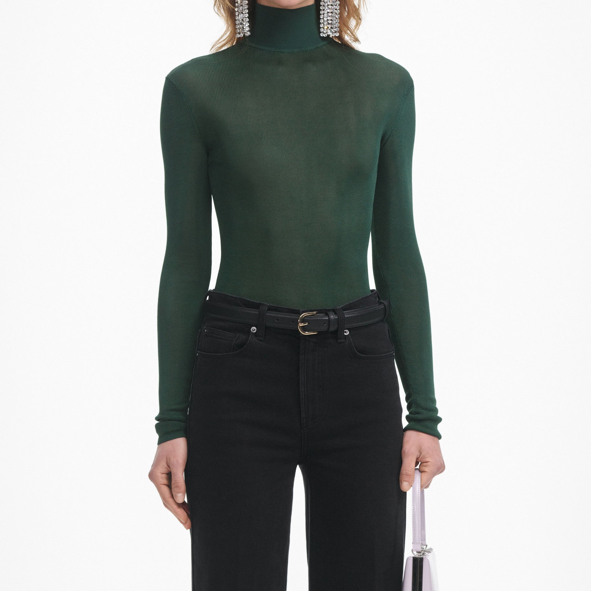 A close up of a woman wearing the Green Viscose Knit Top