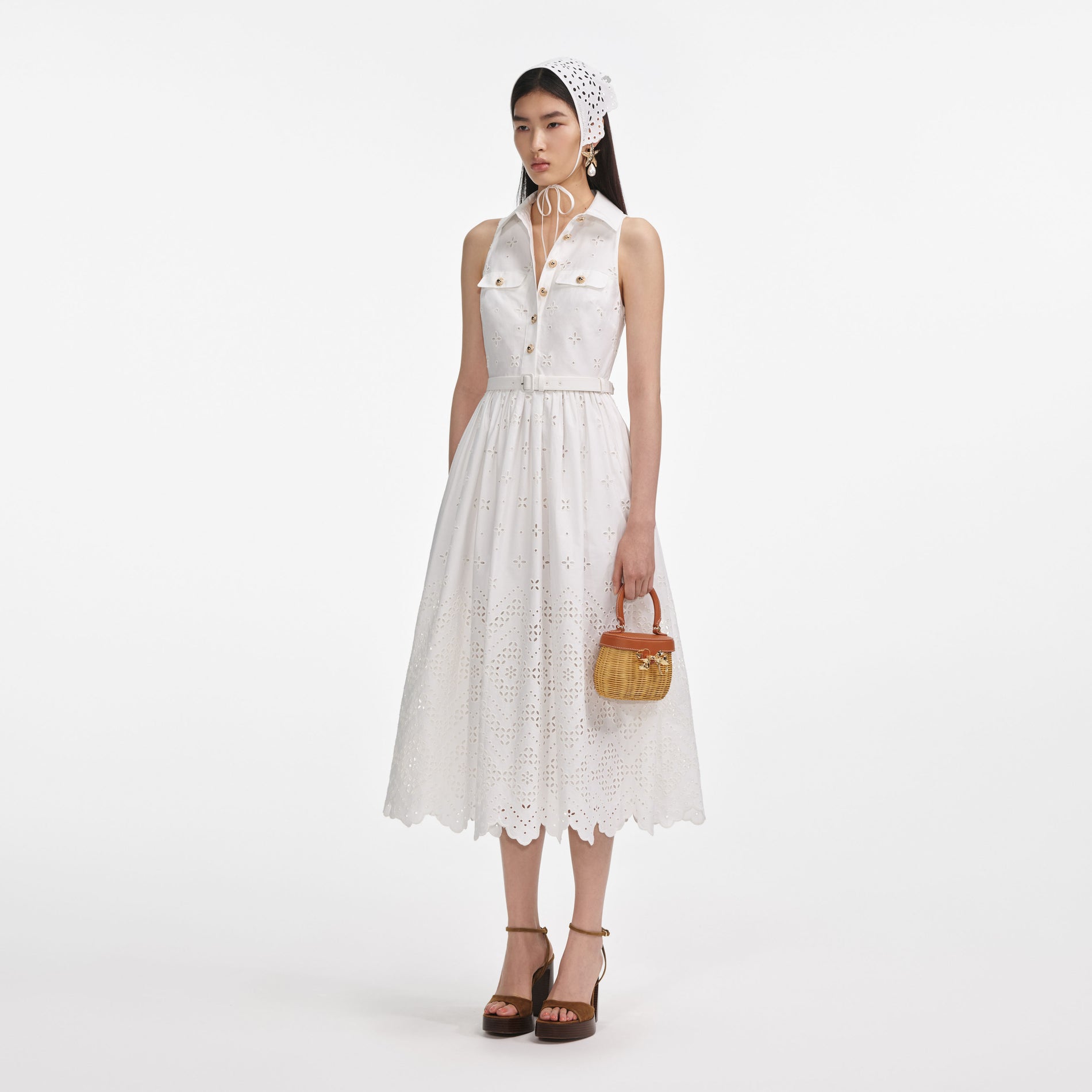 Side view of a woman wearing the White Cotton Broderie Collared Midi Dress