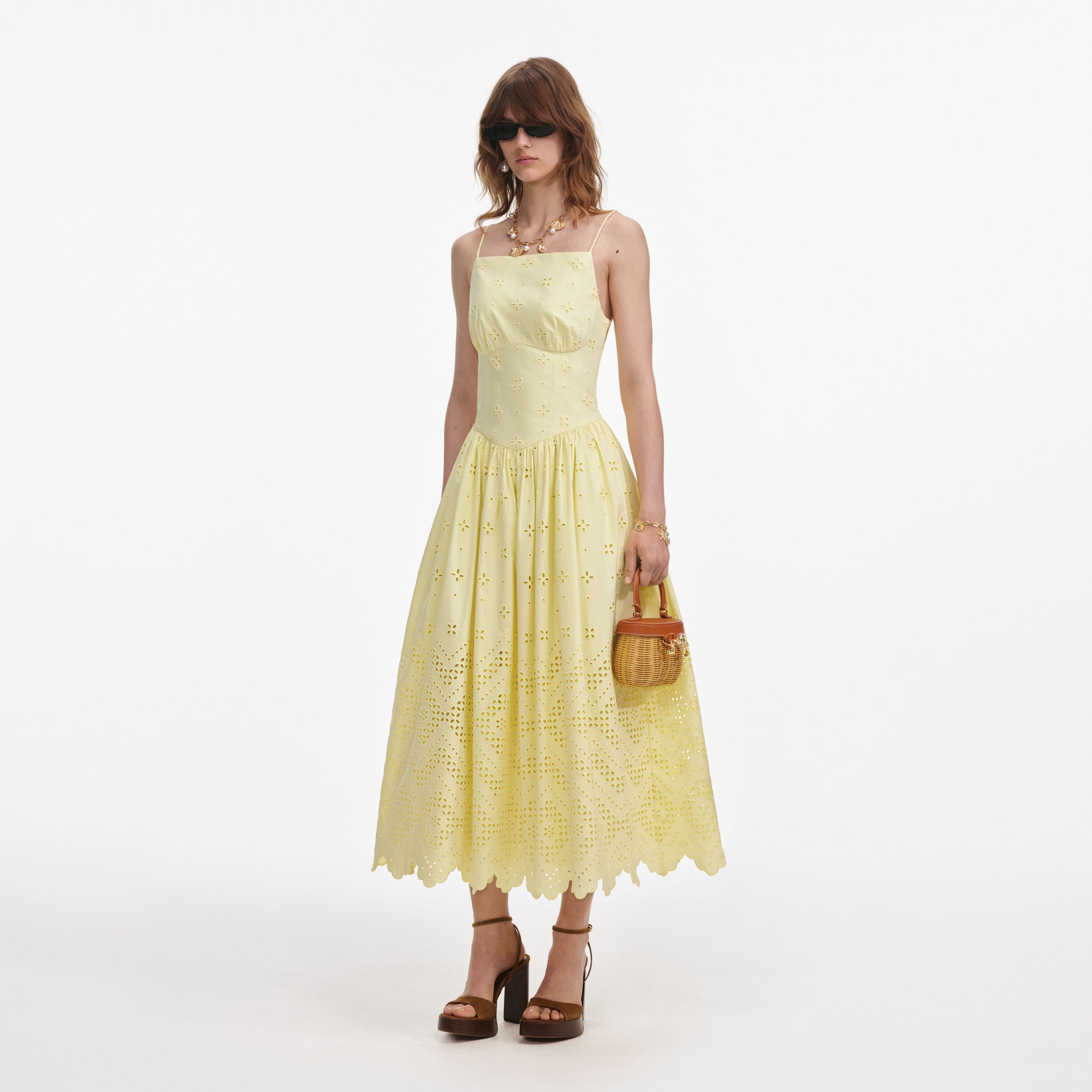 Side view of a woman wearing the Yellow Cotton Broderie Midi Dress