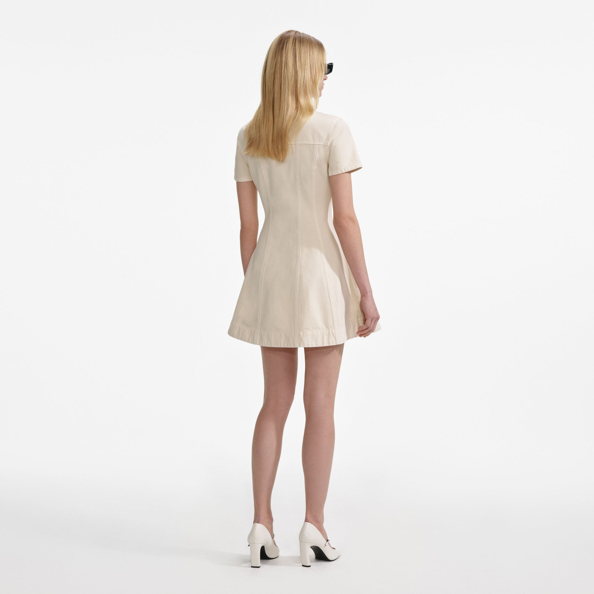 Back view of a woman wearing the Cream Collared Denim Mini Dress