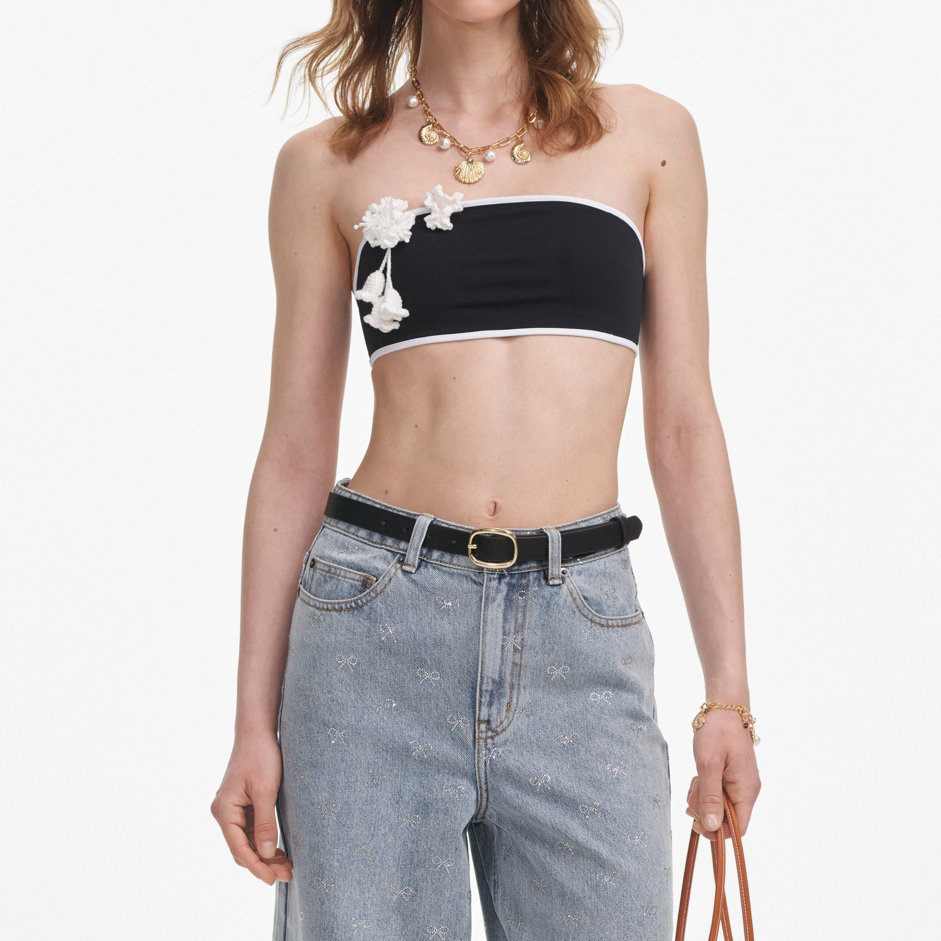 A close up of a woman wearing the Light Blue Diamante Bow Jeans