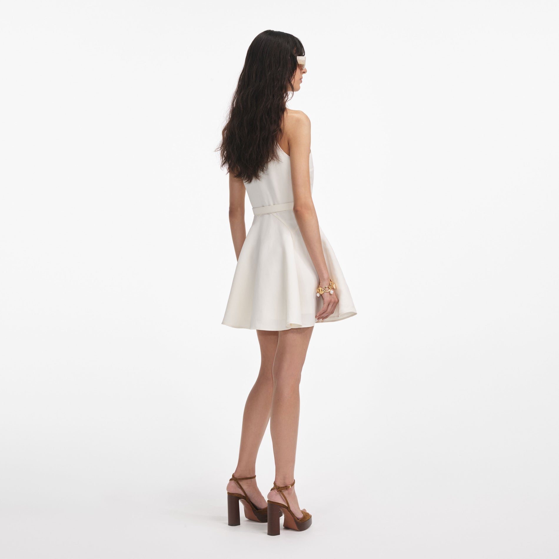 Back view of a woman wearing the Cream Linen Mini Dress