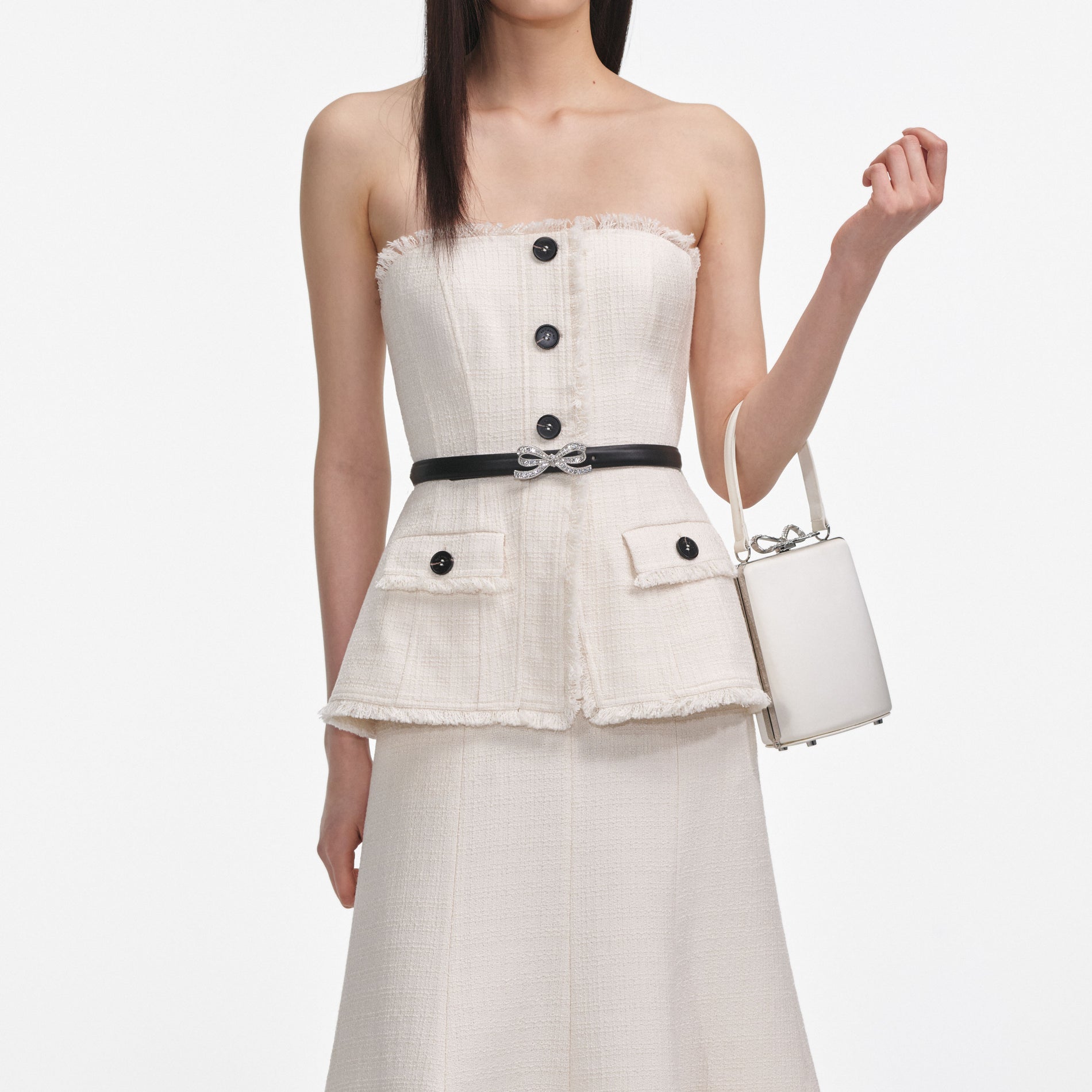 A close up of a woman wearing the Cream Boucle Bandeau Midi Dress