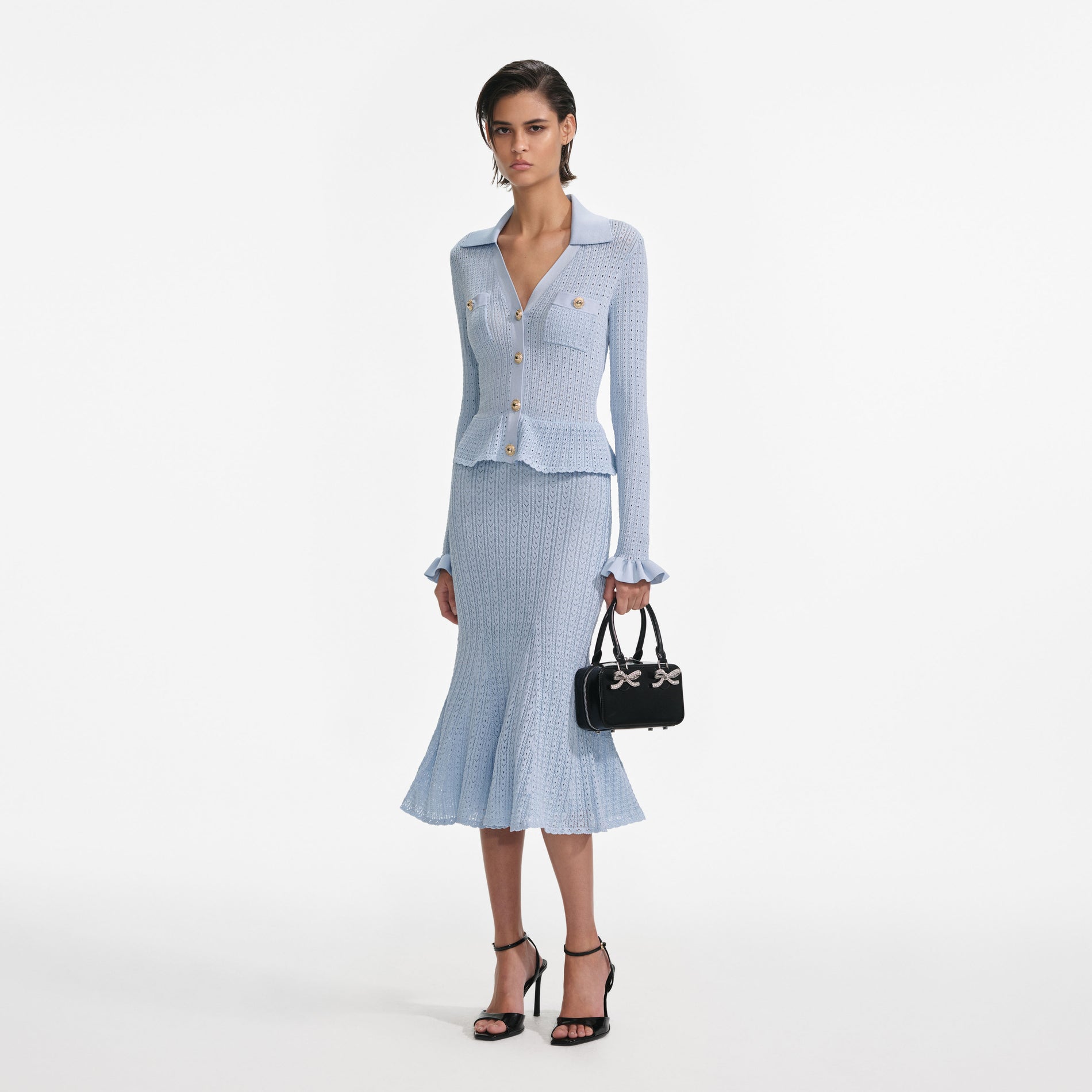 Side view of a woman wearing the Blue Pointelle Knit Midi Dress